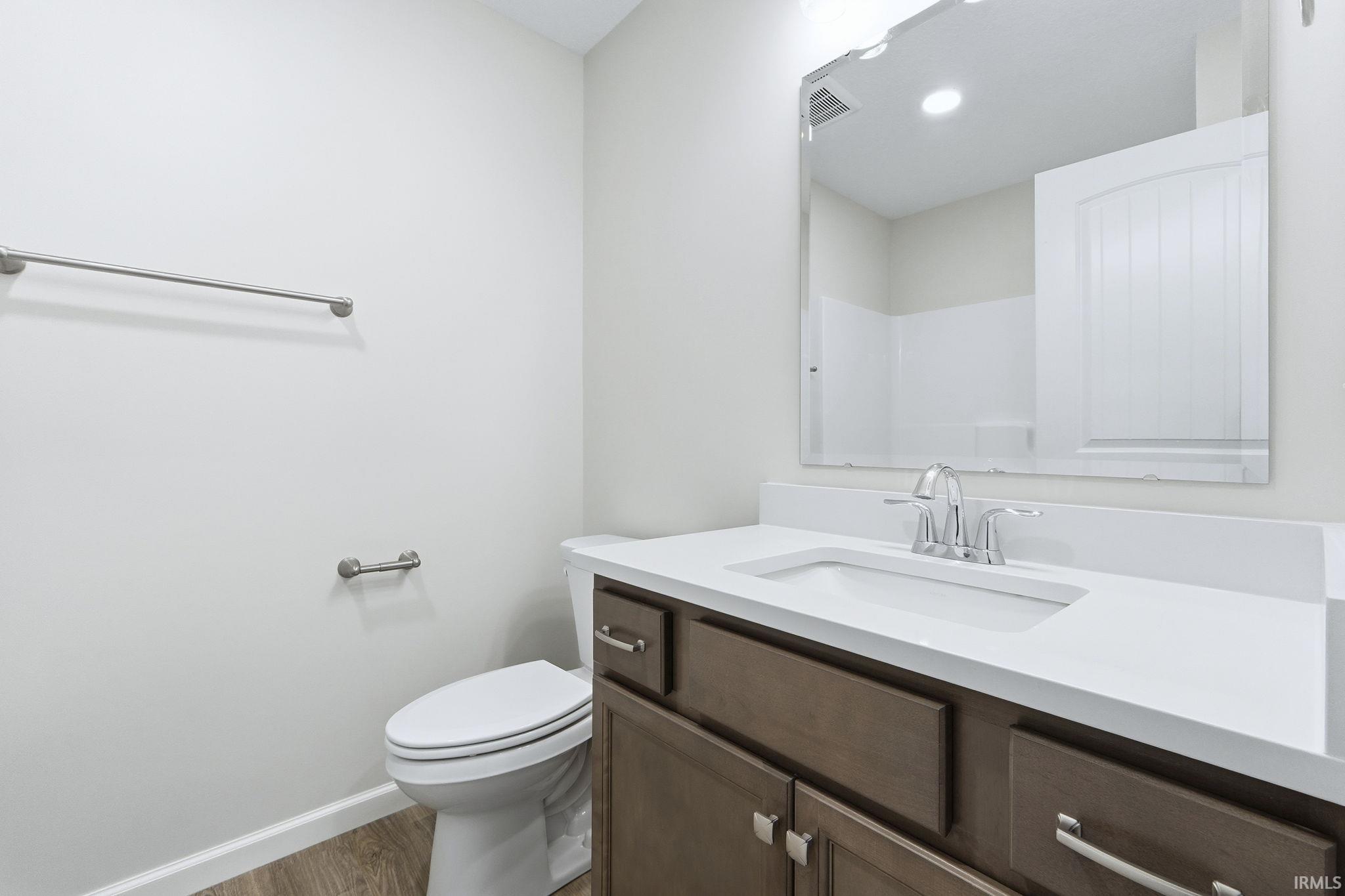 Bathroom featuring vanity and wood finished floors