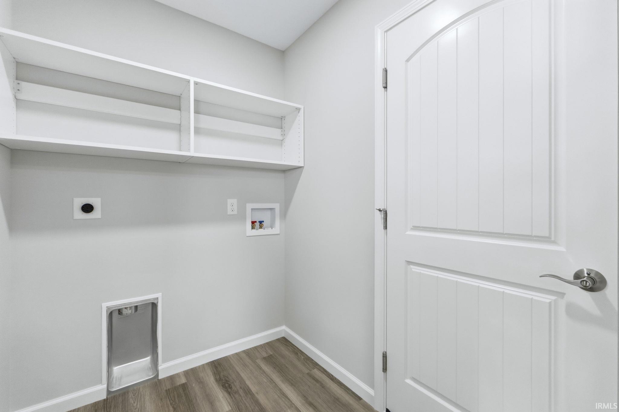 Laundry area featuring electric dryer hookup, hookup for a washing machine, and dark wood-type flooring