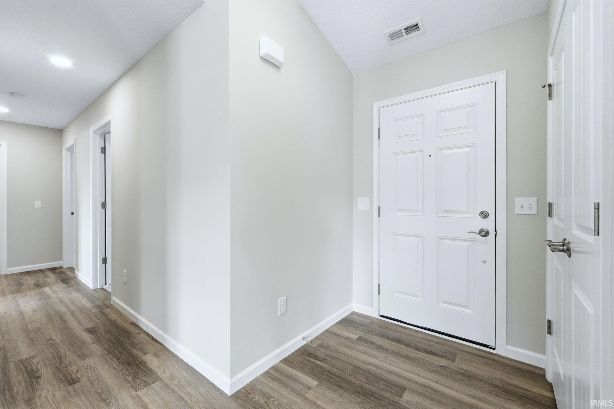 Foyer entrance with wood finished floors