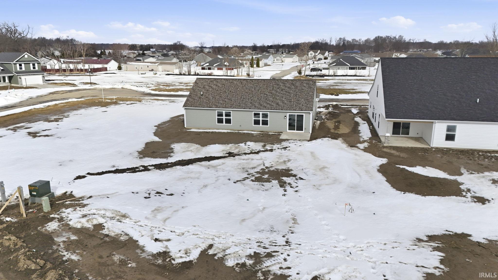 Snowy aerial view featuring a residential view