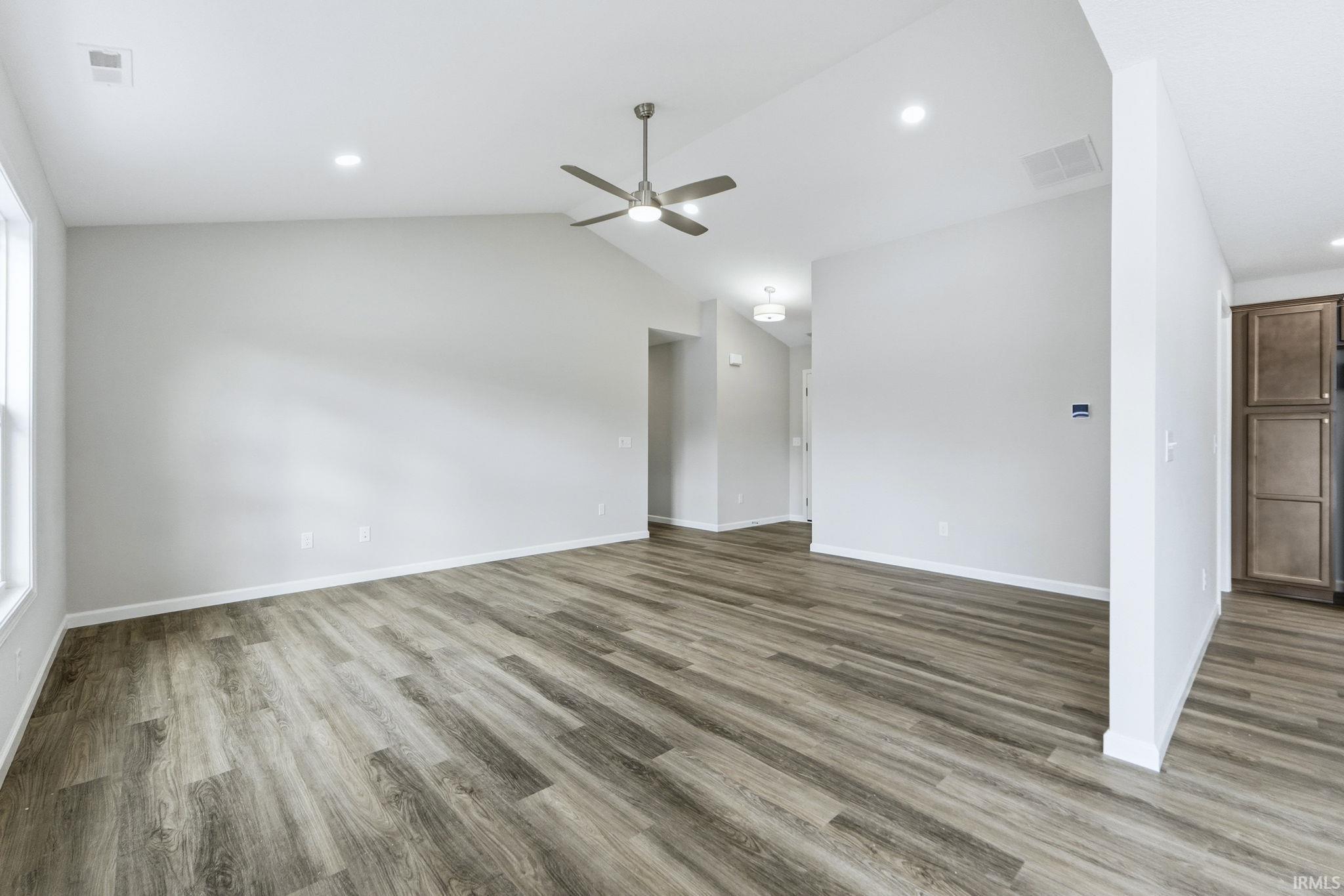 Unfurnished living room with light wood-type flooring, ceiling fan, and recessed lighting