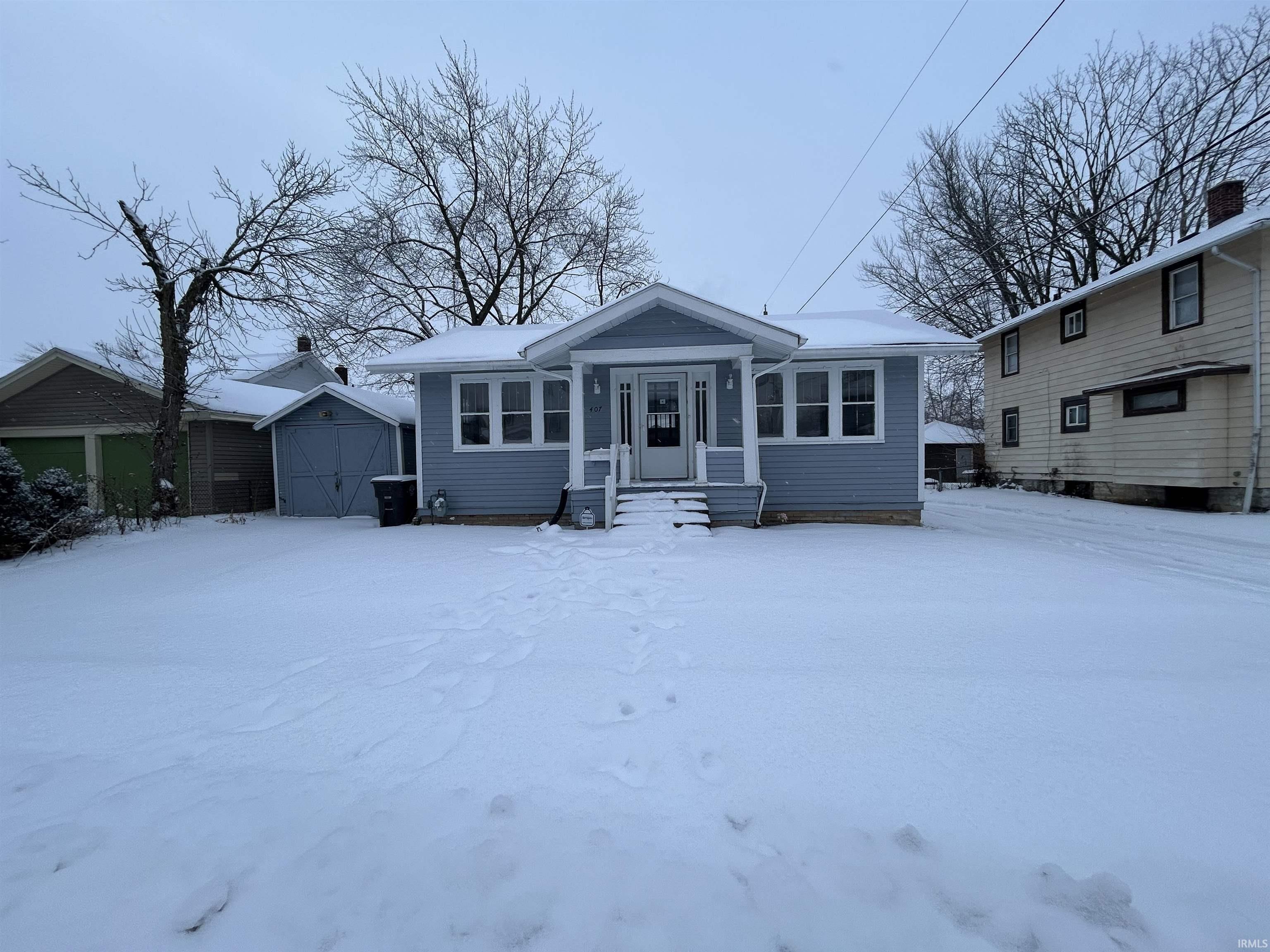 Bungalow featuring a shed