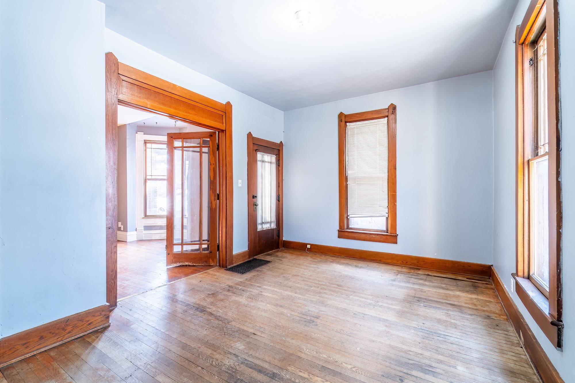 Bedroom or Bonus Room with exterior entrance featuring hardwood floors and baseboards
