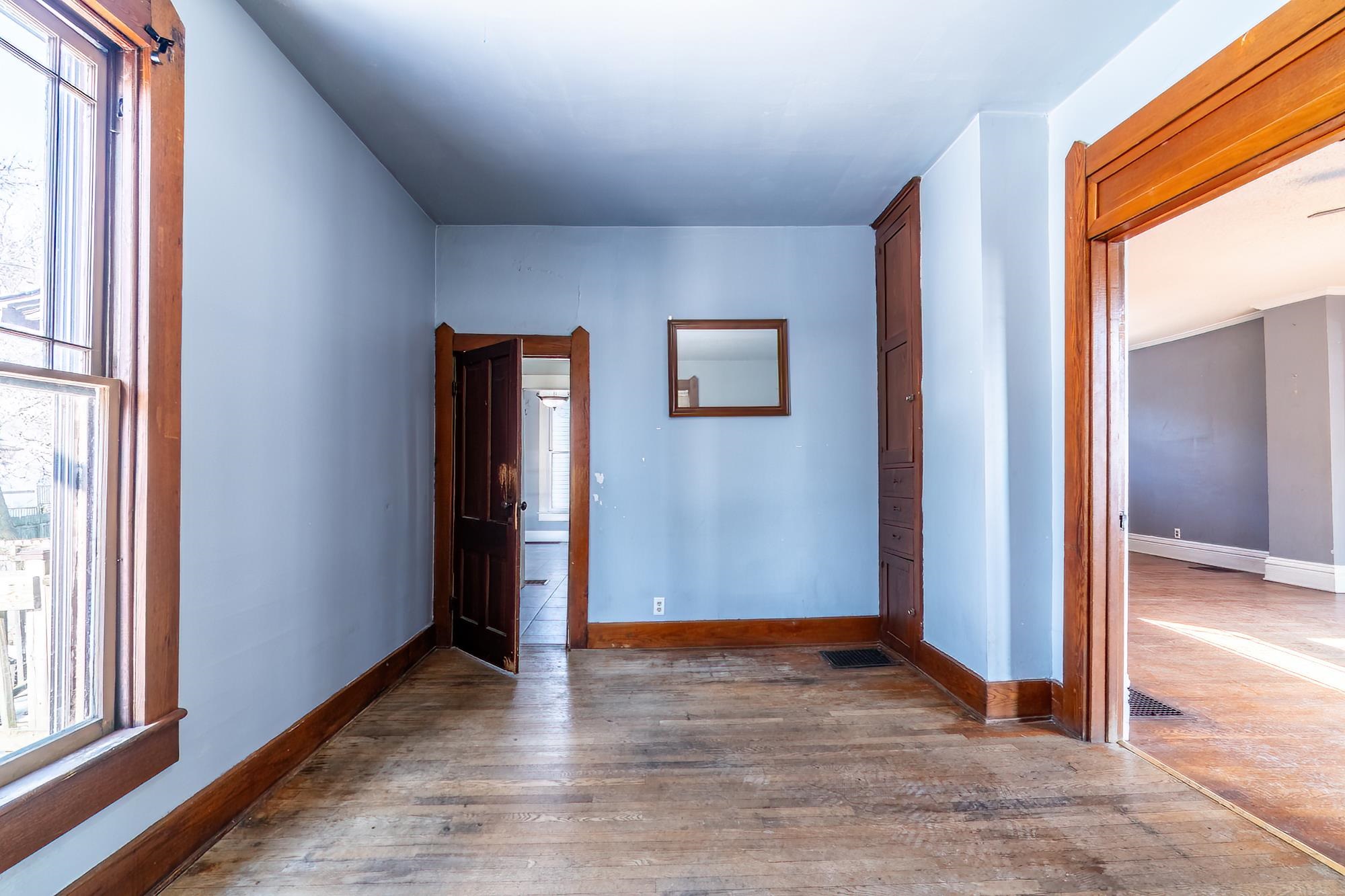 Bedroom or Bonus Room with exterior entrance featuring hardwood floors and baseboards