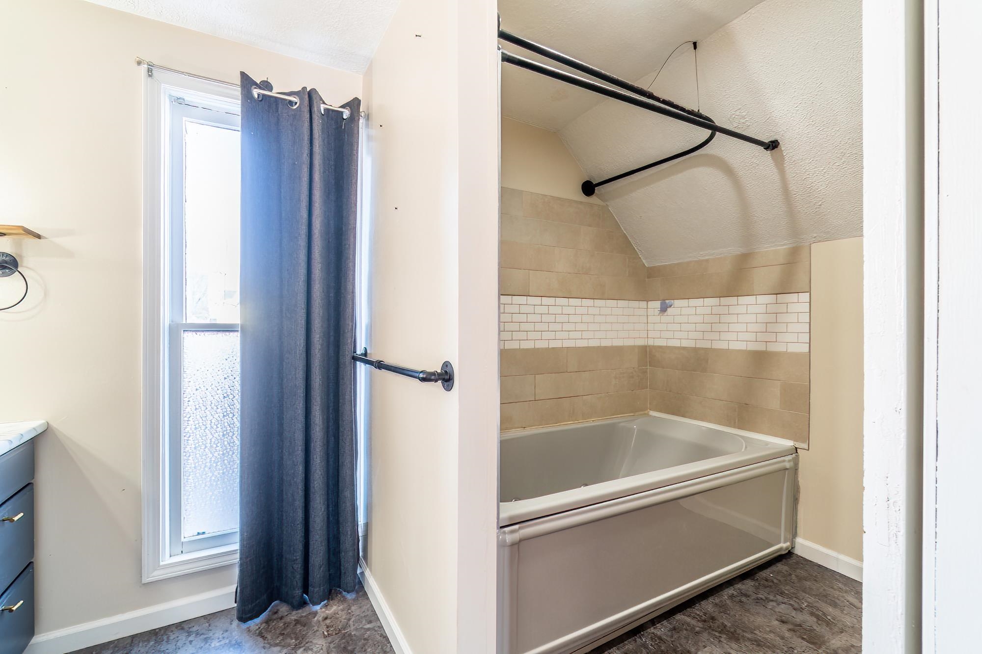 Full bath with vanity and bathtub / shower combination