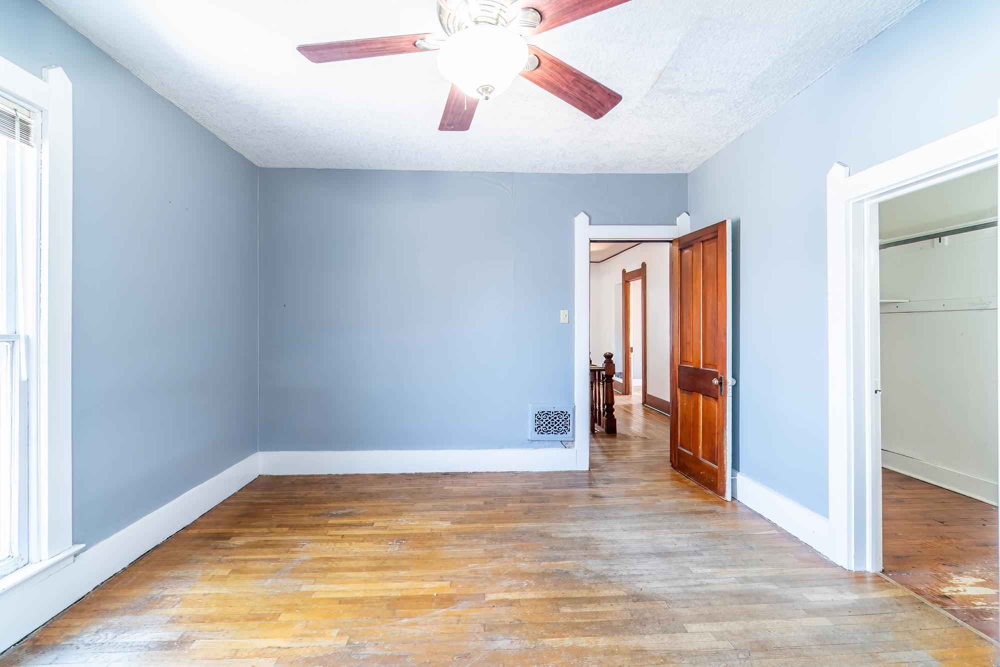 Unfurnished bedroom with hardwood floors, a textured ceiling, and ceiling fan