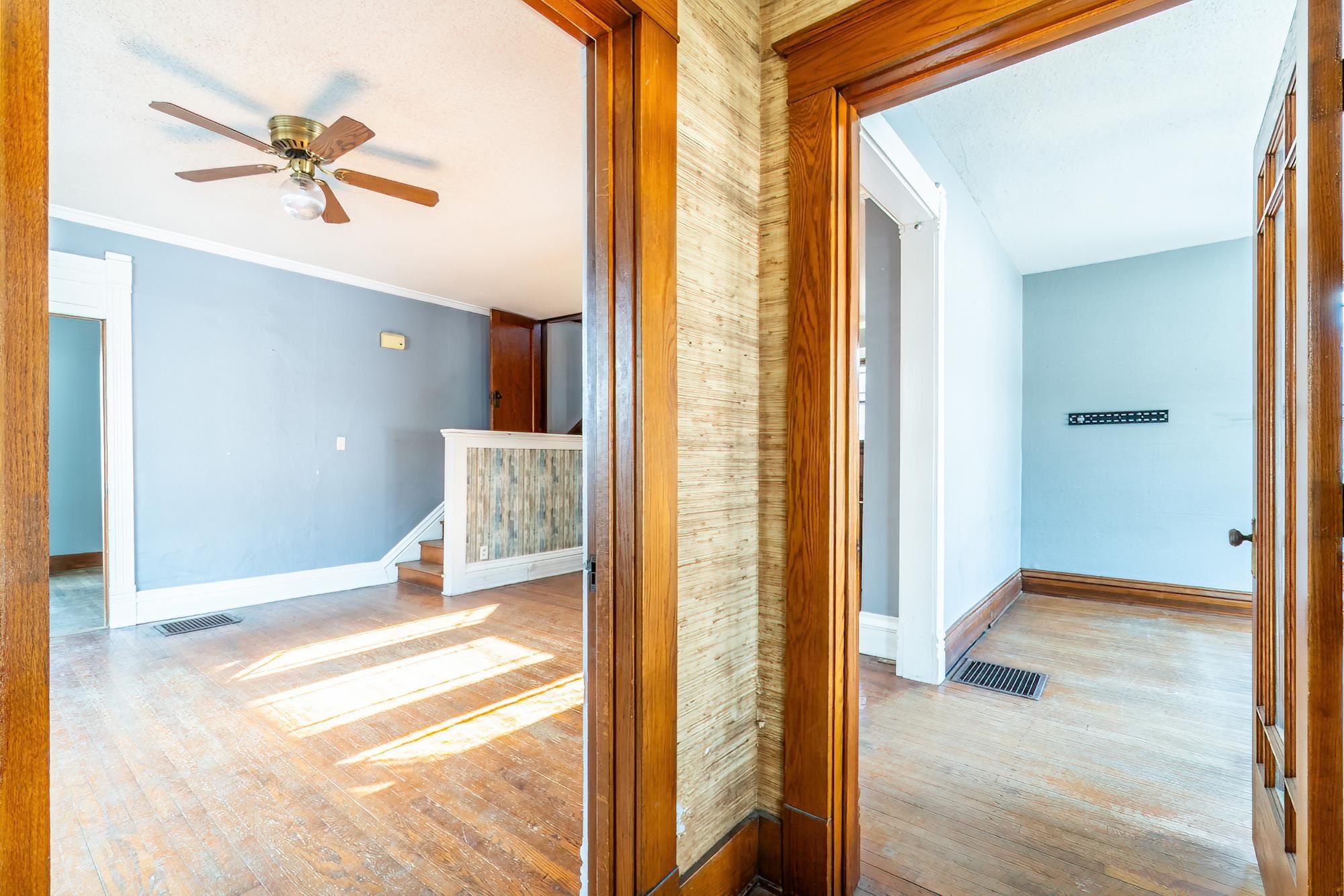 Corridor featuring wood flooring and crown molding