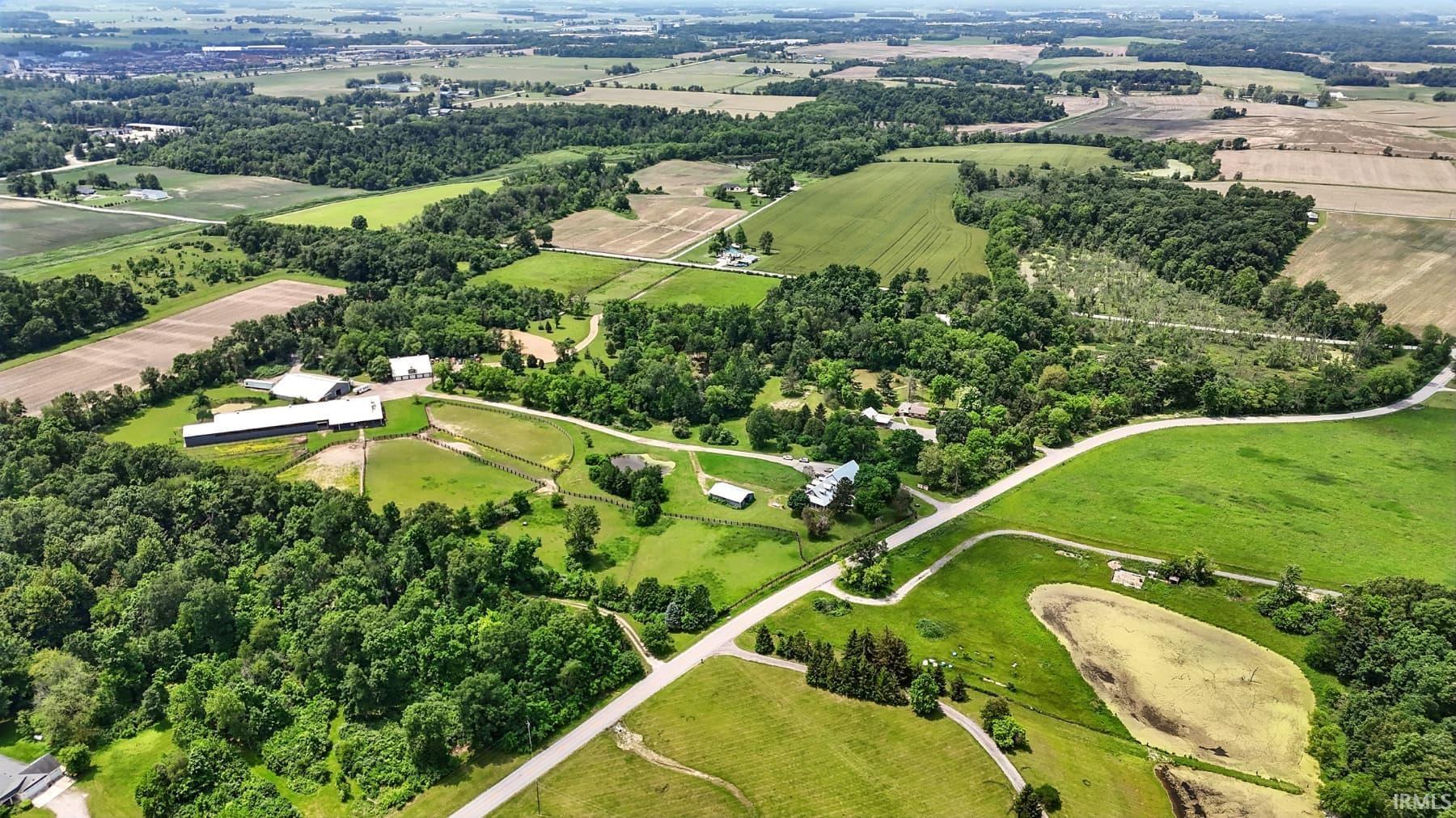 Aerial view of sparsely populated area featuring a tree filled landscape