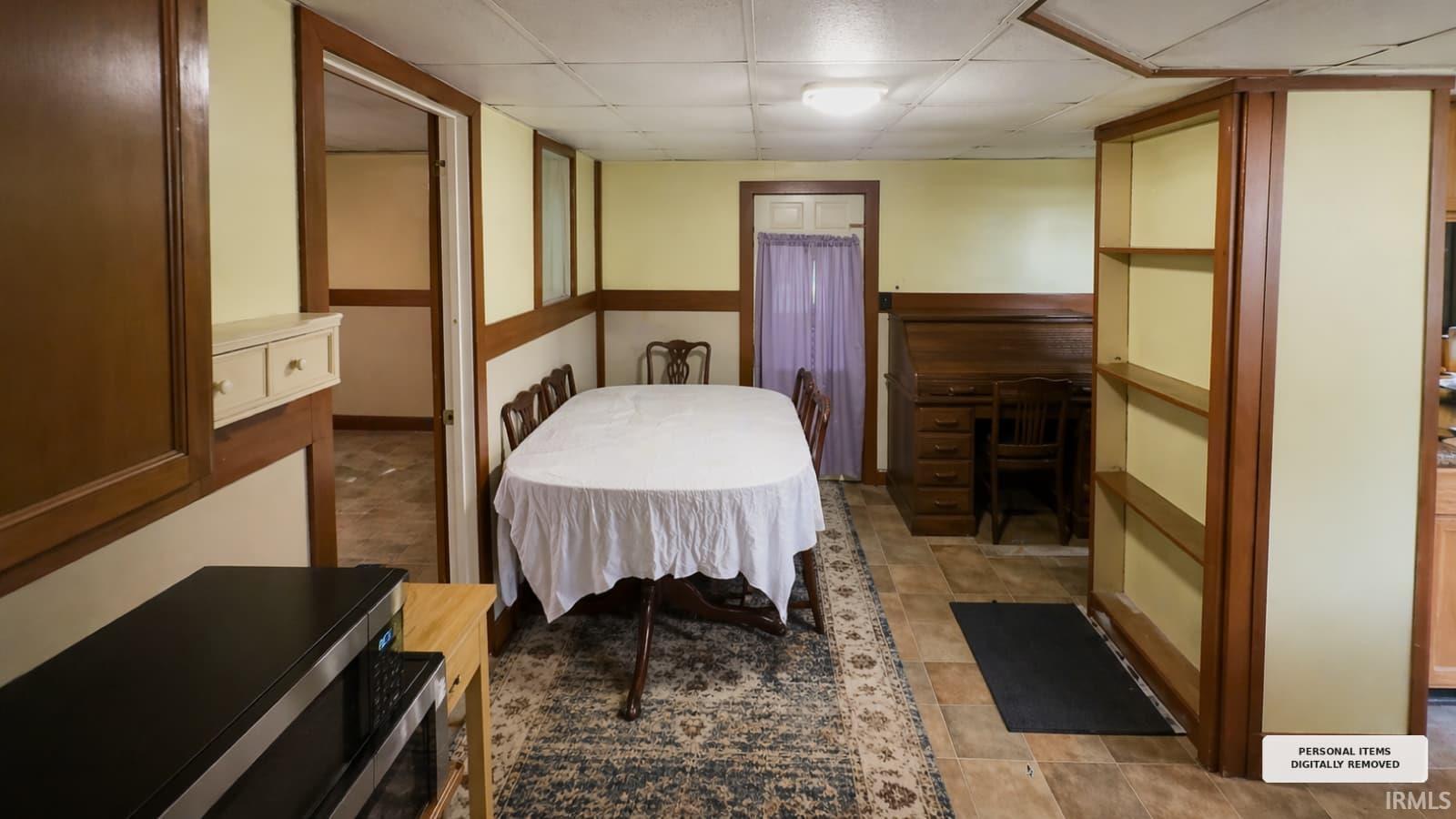 Spacious room featuring wood-finish flooring and light-colored walls with wood trim