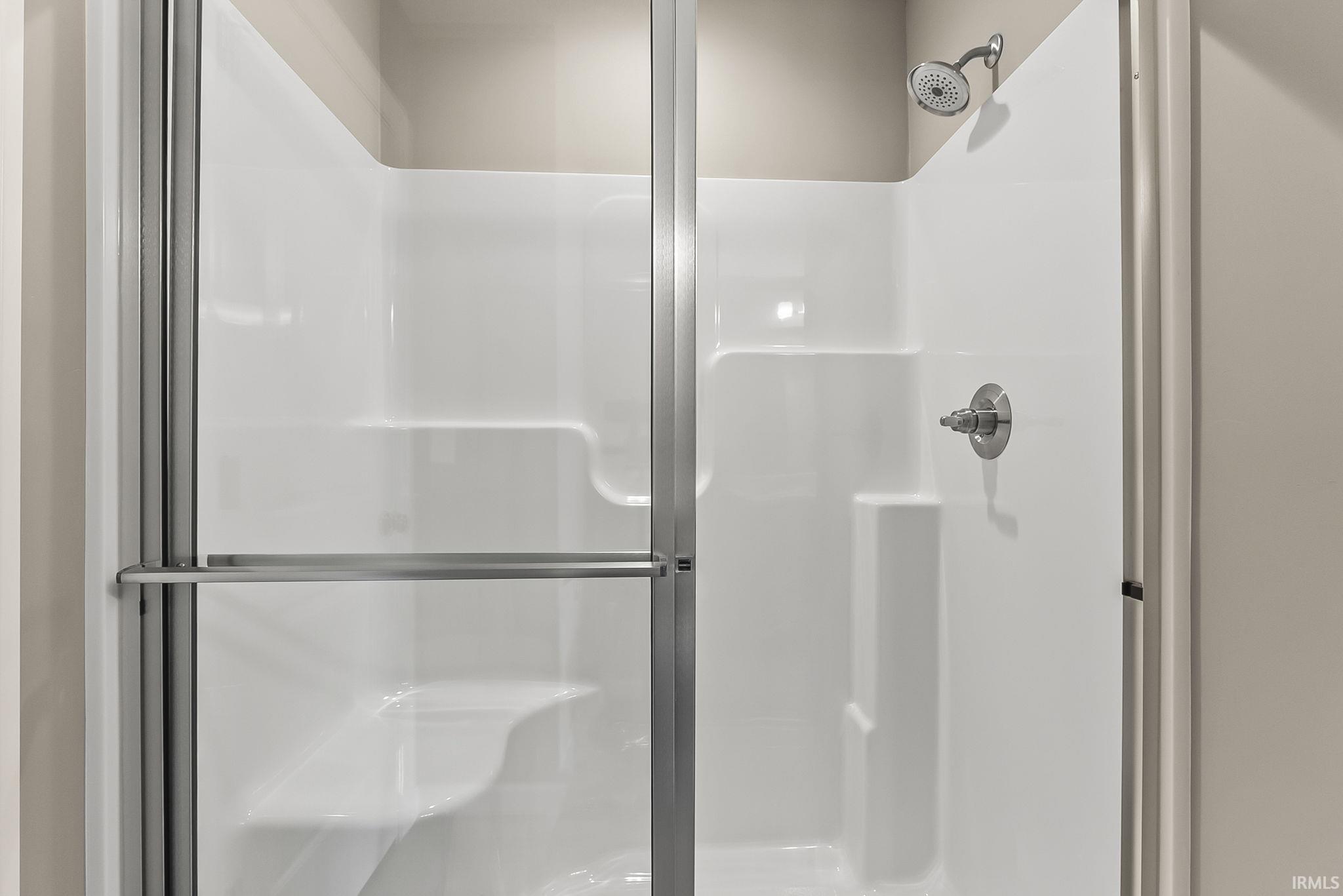 Full bathroom featuring a stall shower