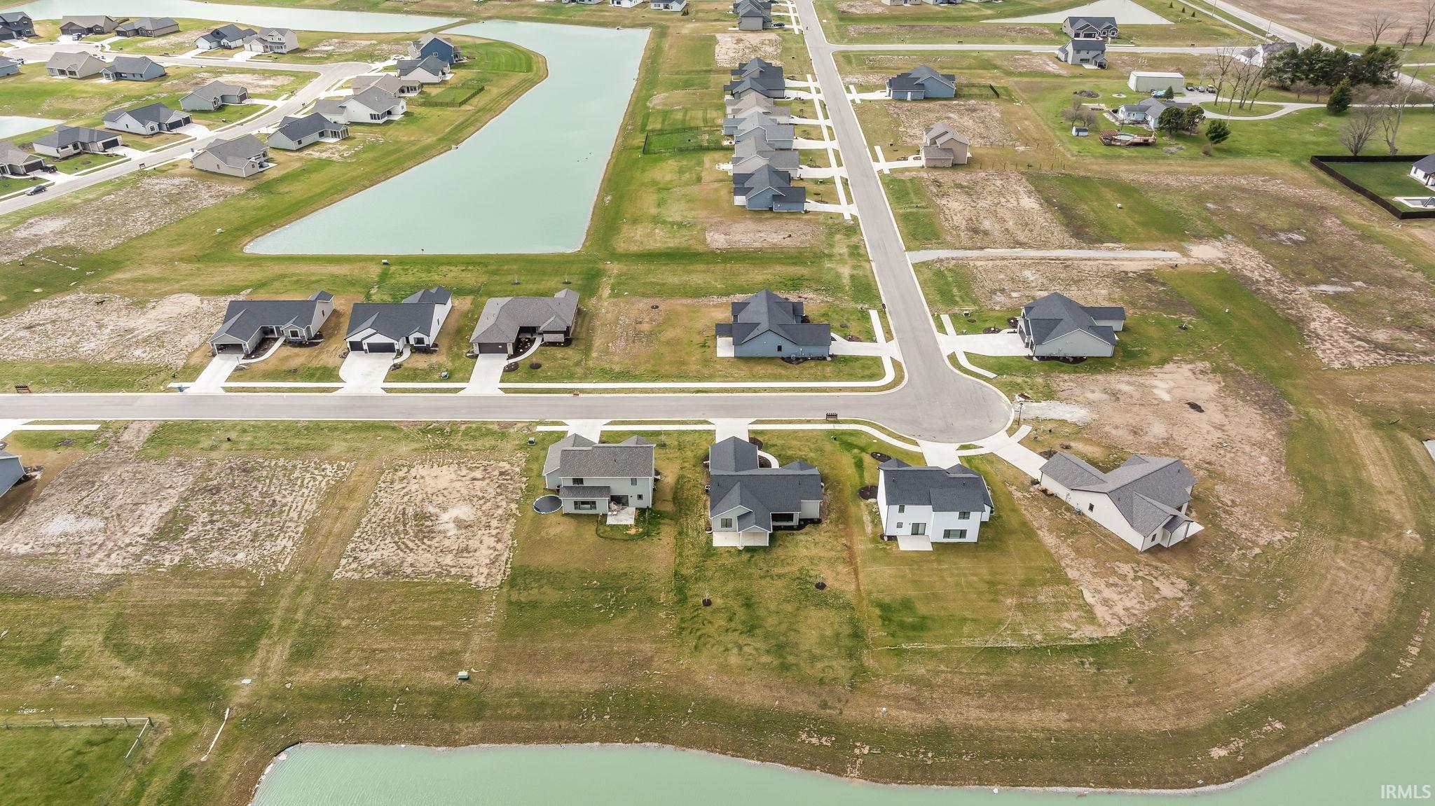 Aerial view of property's location with nearby suburban area and a large body of water