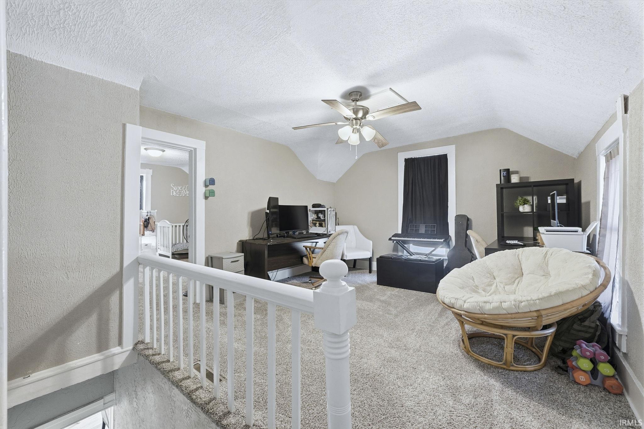 Carpeted office with a ceiling fan
