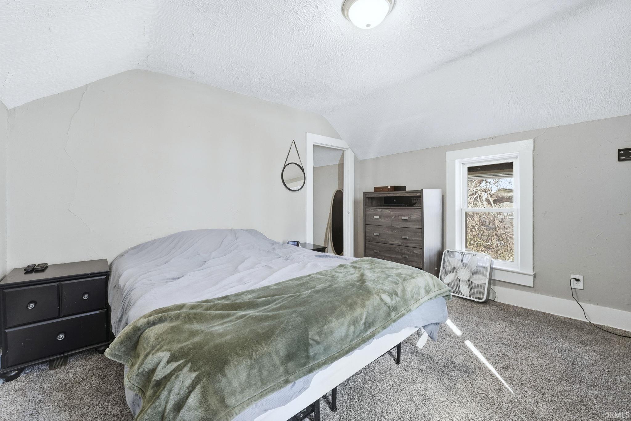 Carpeted bedroom with baseboards