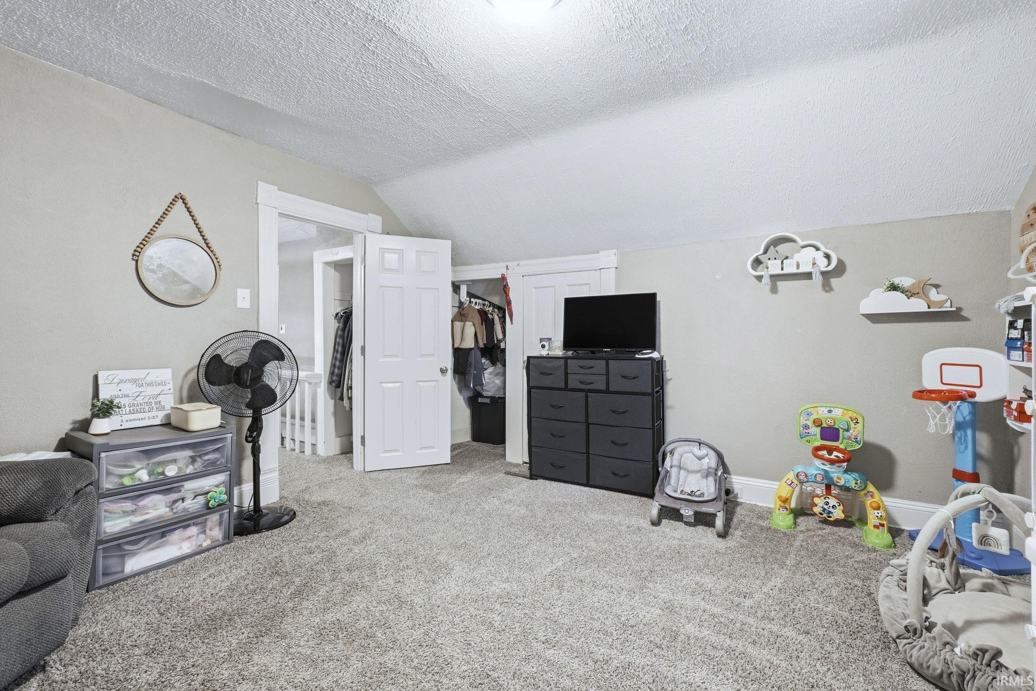 Carpeted bedroom featuring baseboards