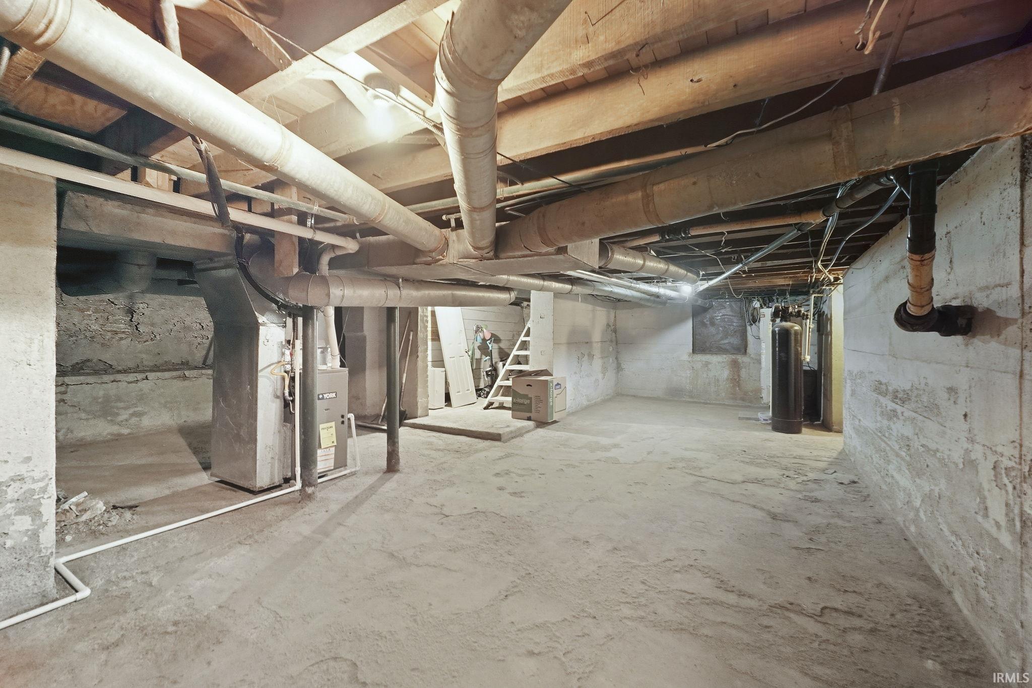 Unfinished below grade area with heating unit and a water softener system