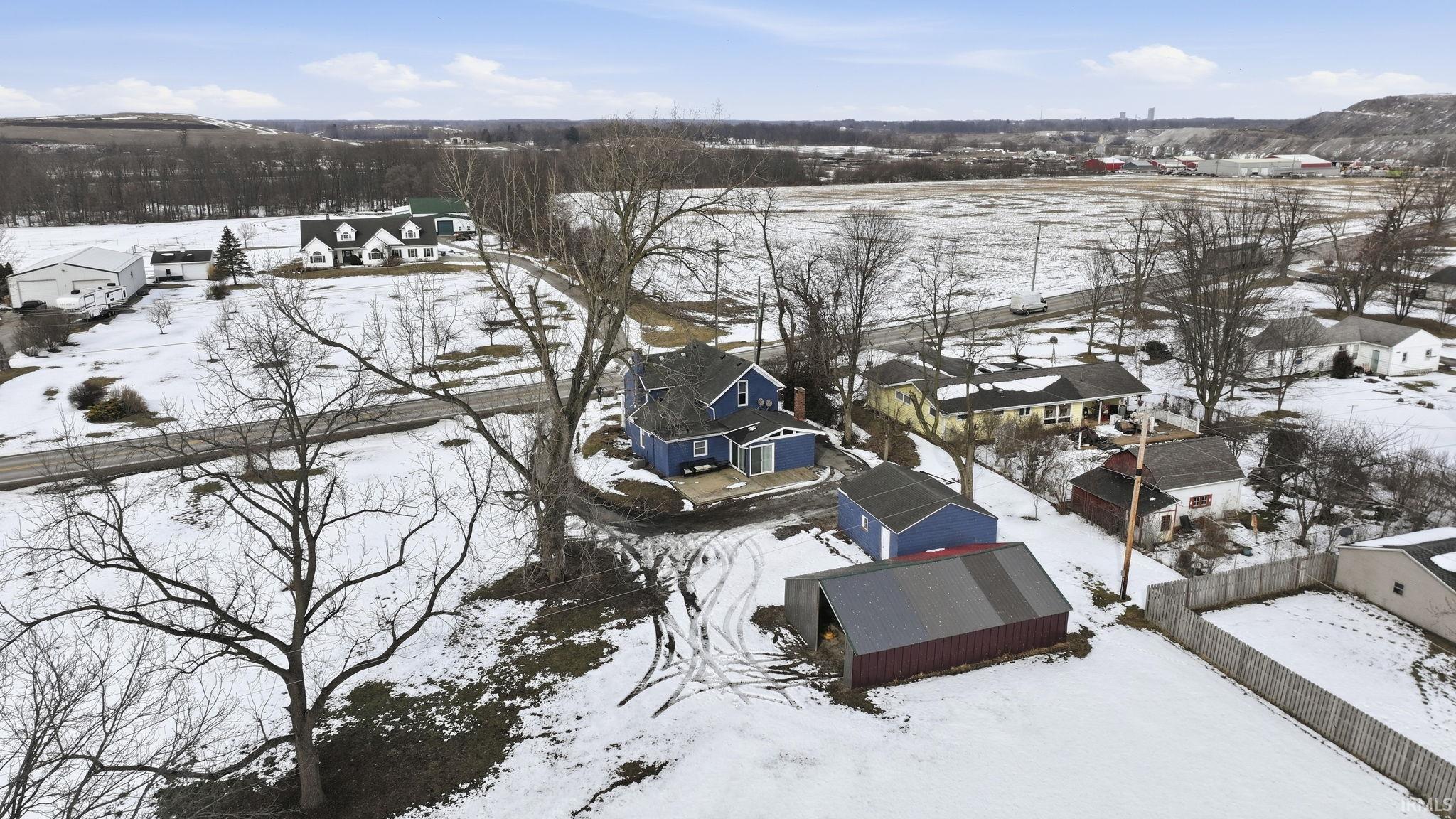 Snowy aerial view featuring a residential view