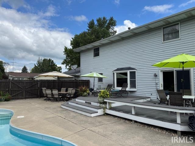 Back of house featuring outdoor dining area, a deck, and a patio