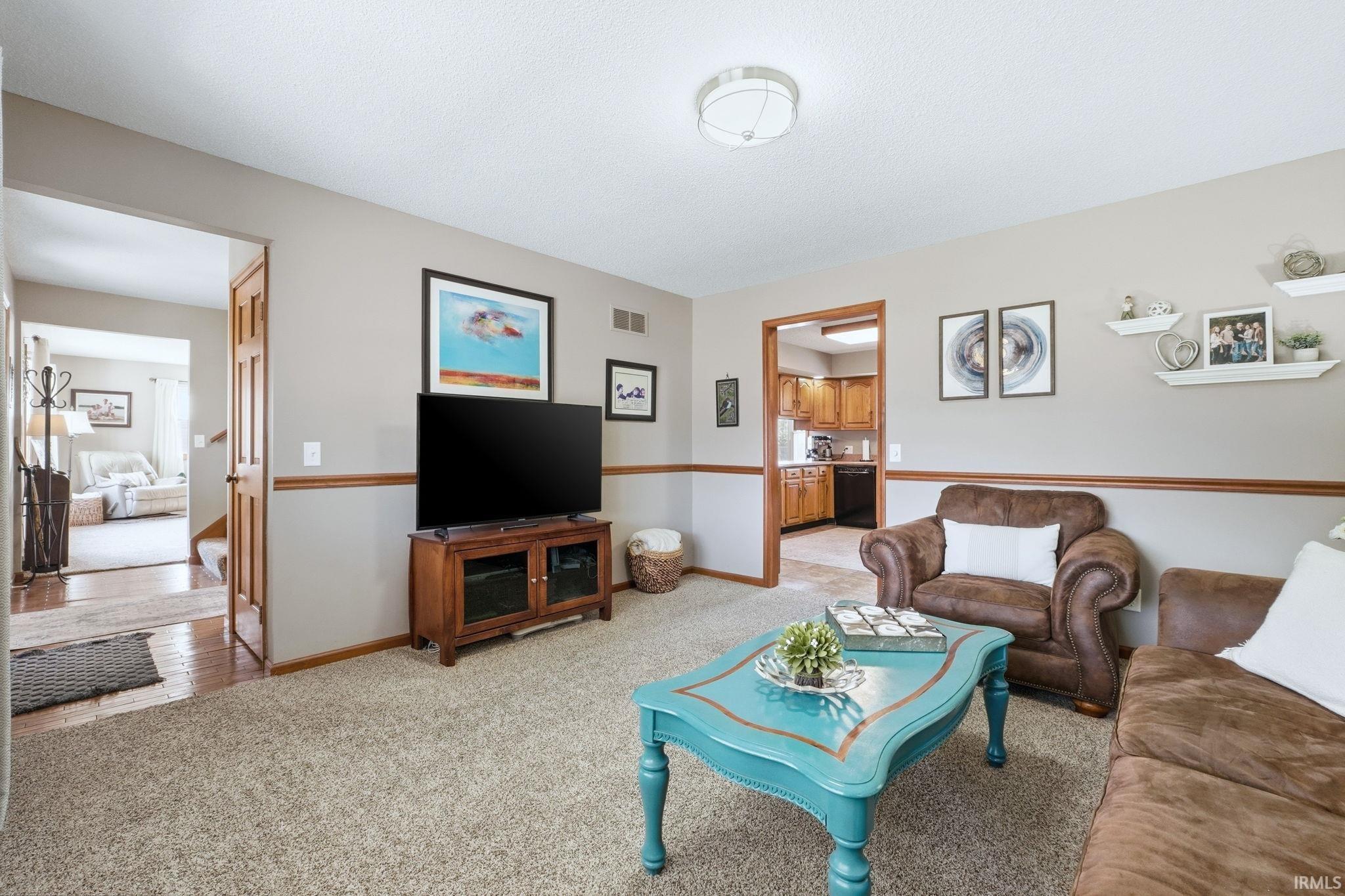 Living room with light carpet and baseboards