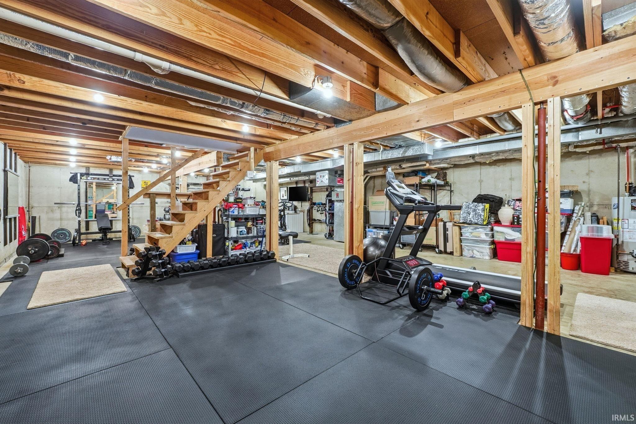 Workout area with rubber floors and gas water heater