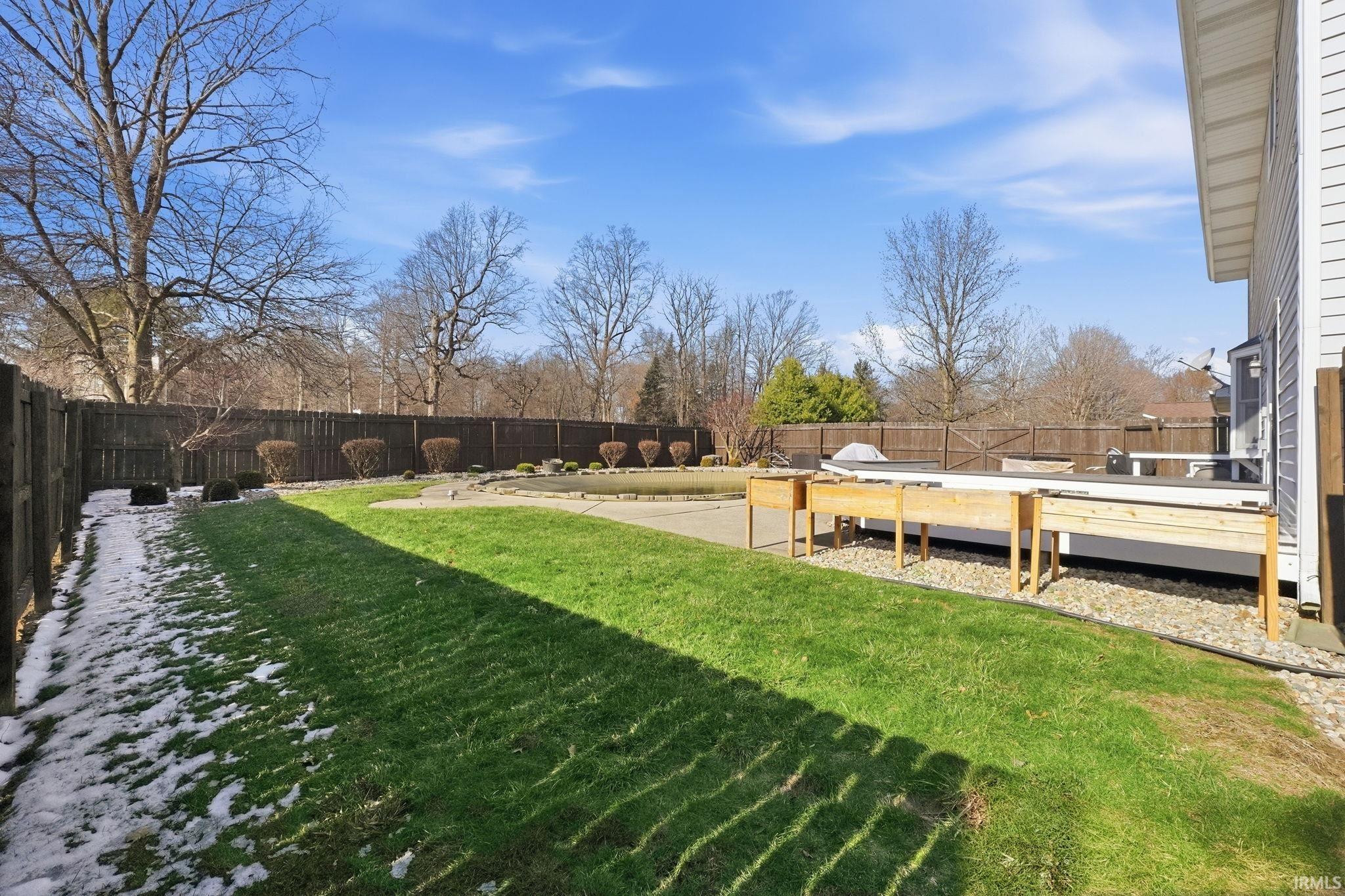 Fenced backyard with a wooden deck