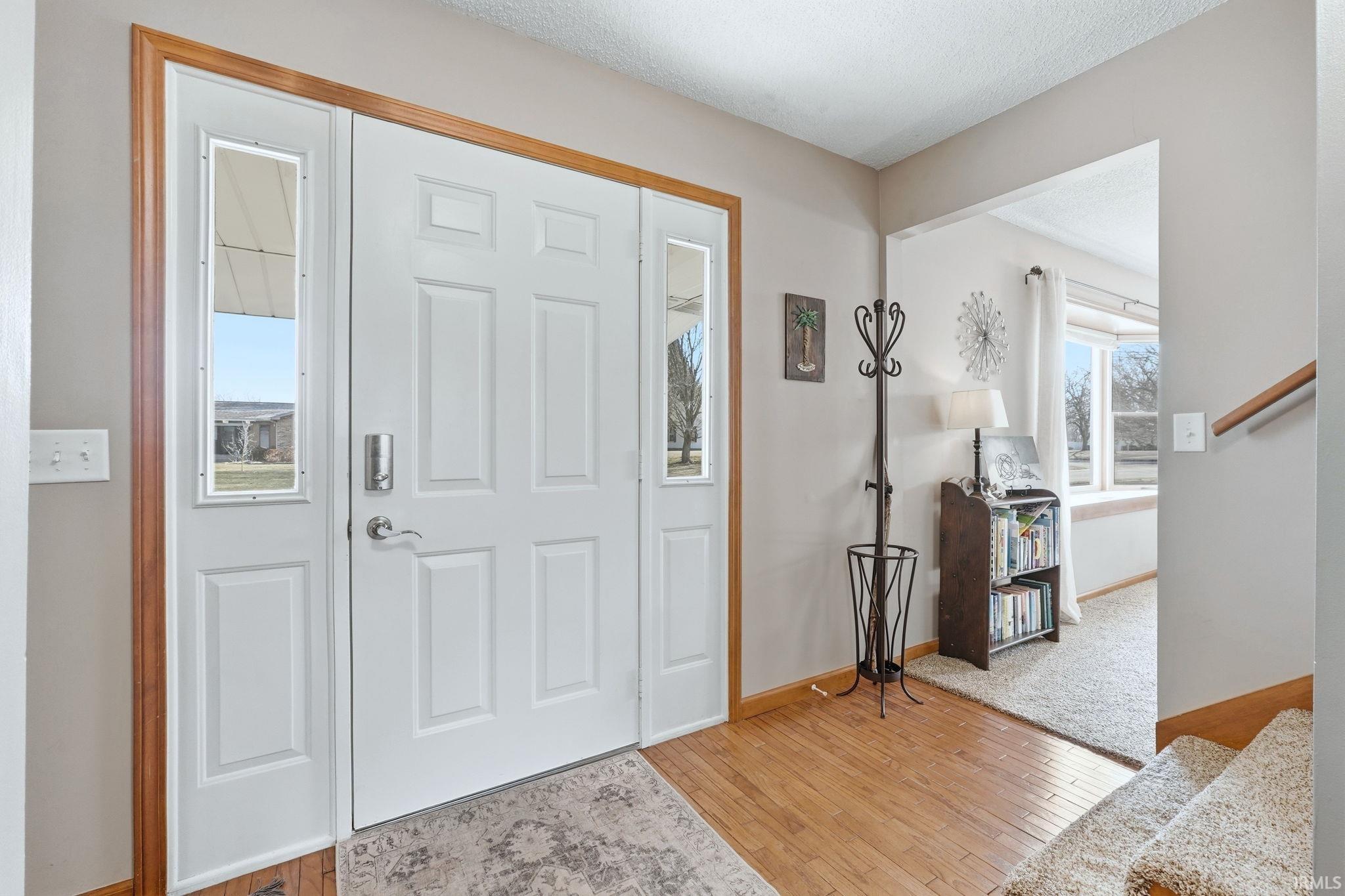 Entrance foyer featuring light wood-type flooring and baseboards