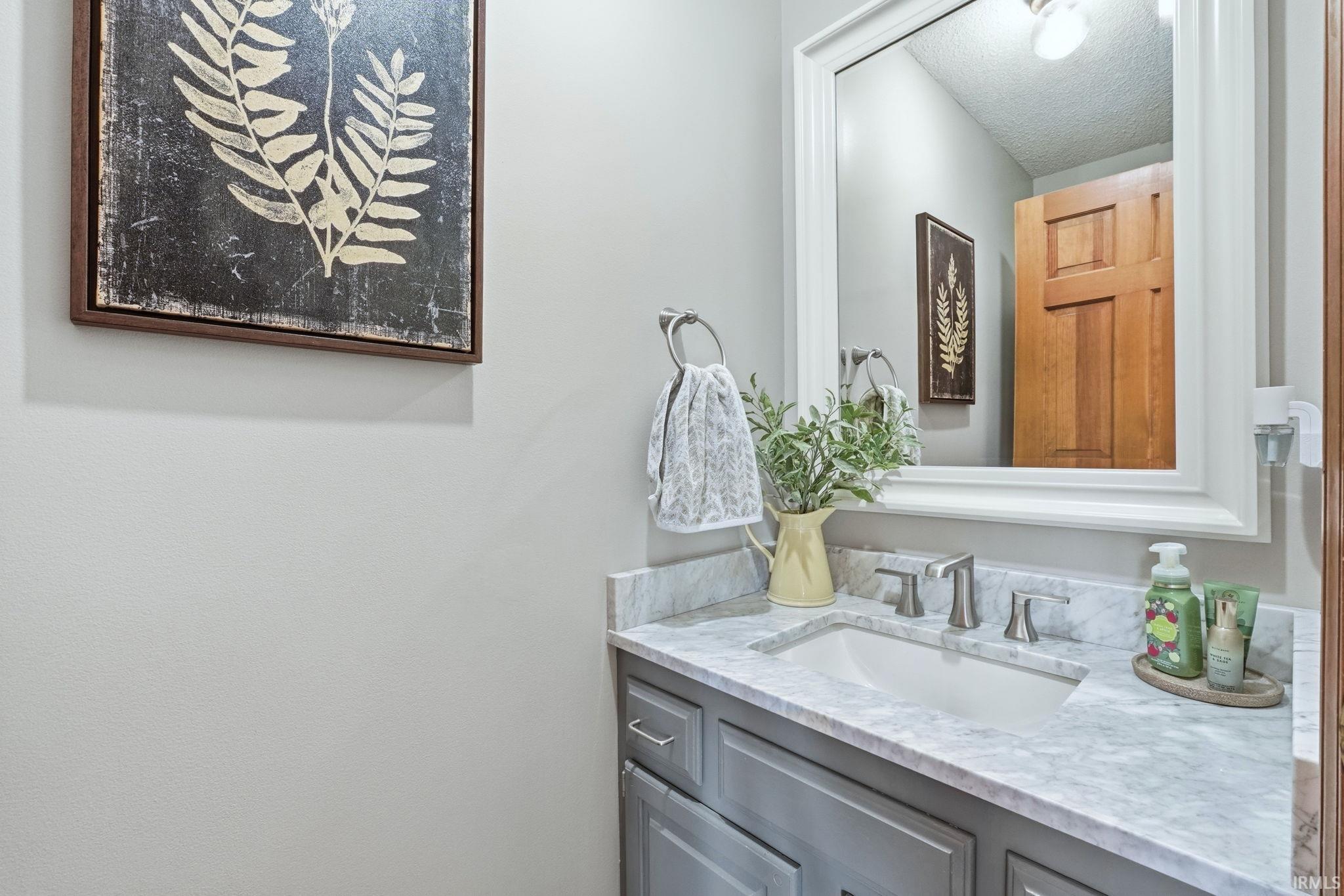 Bathroom with vanity and a textured ceiling