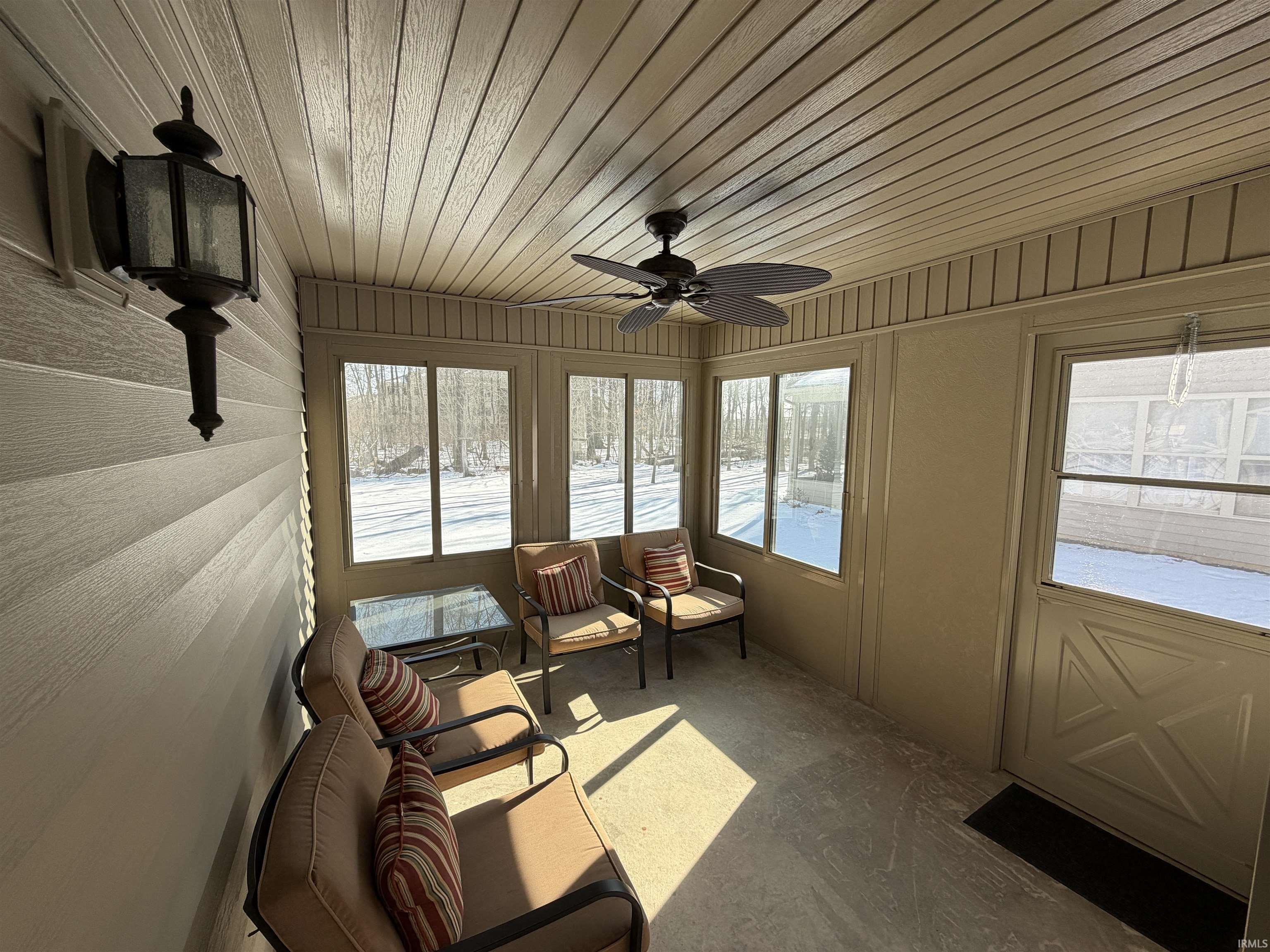 Sunroom / solarium with ceiling fan and healthy amount of natural light