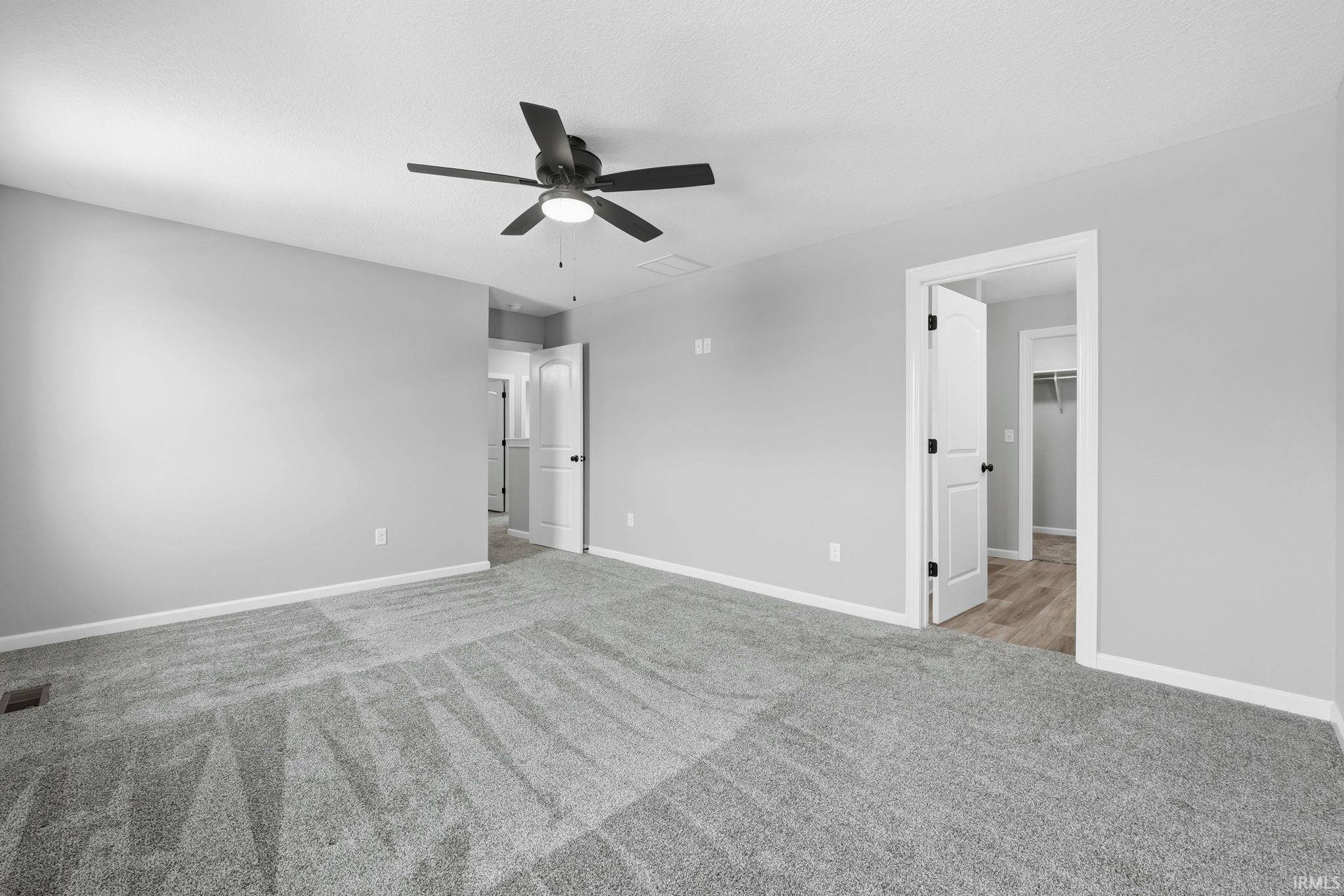 Unfurnished bedroom featuring carpet and a ceiling fan