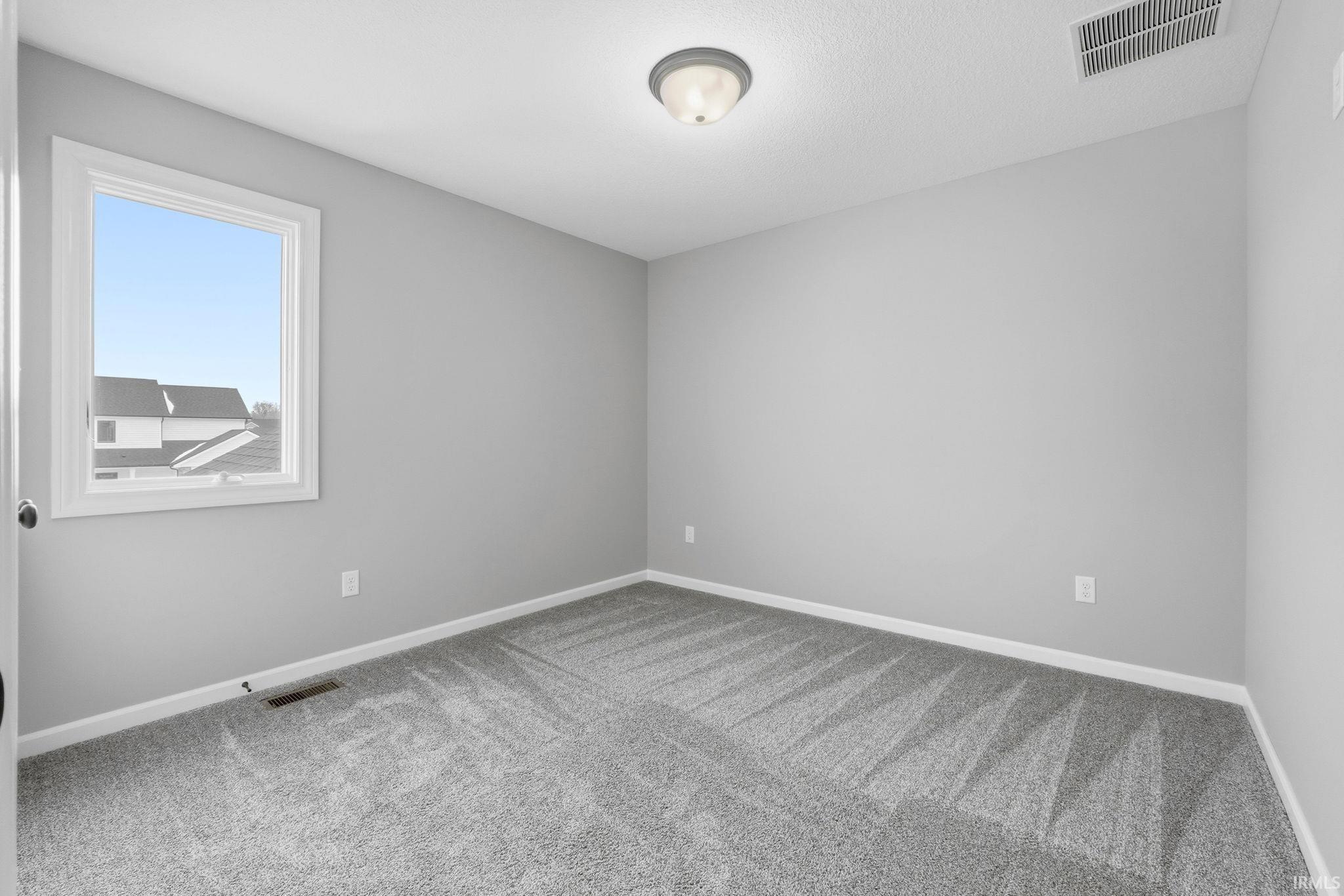 Spare room with baseboards and carpet floors