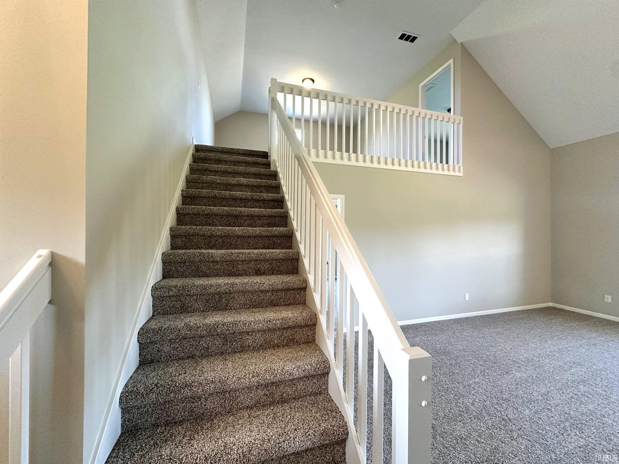 Stairs with carpet floors and baseboards