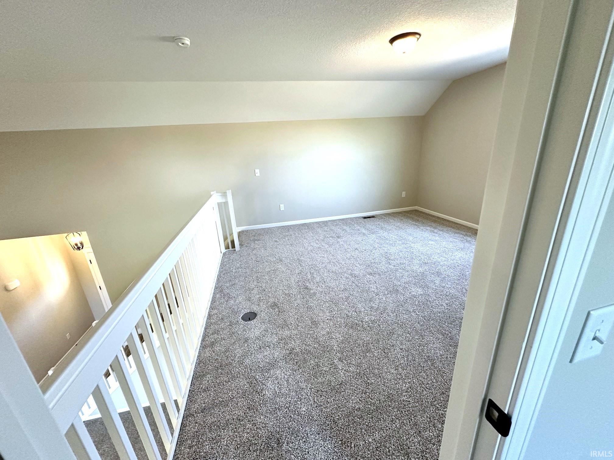 Additional living space featuring carpet floors and baseboards