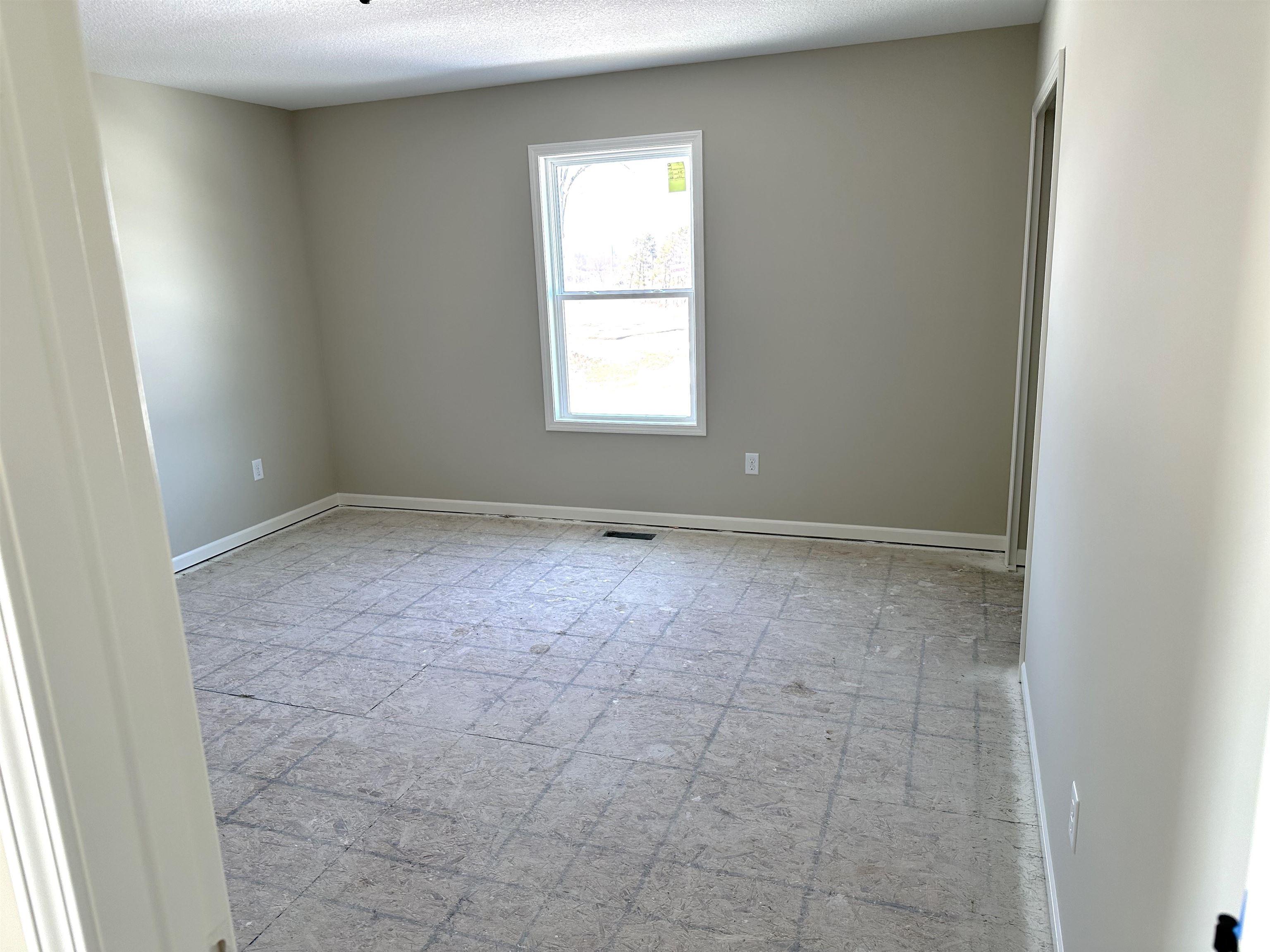 Spare room featuring baseboards