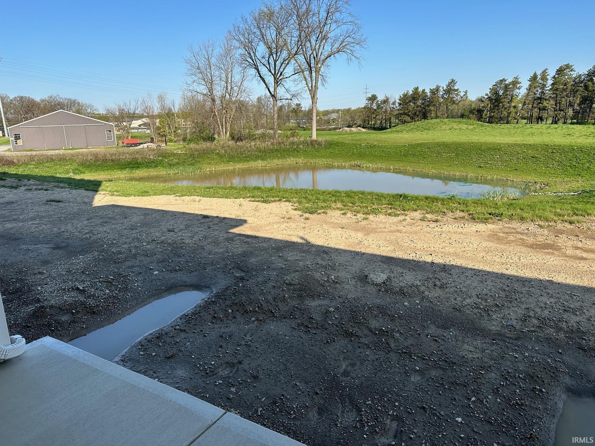 View of yard with a water view