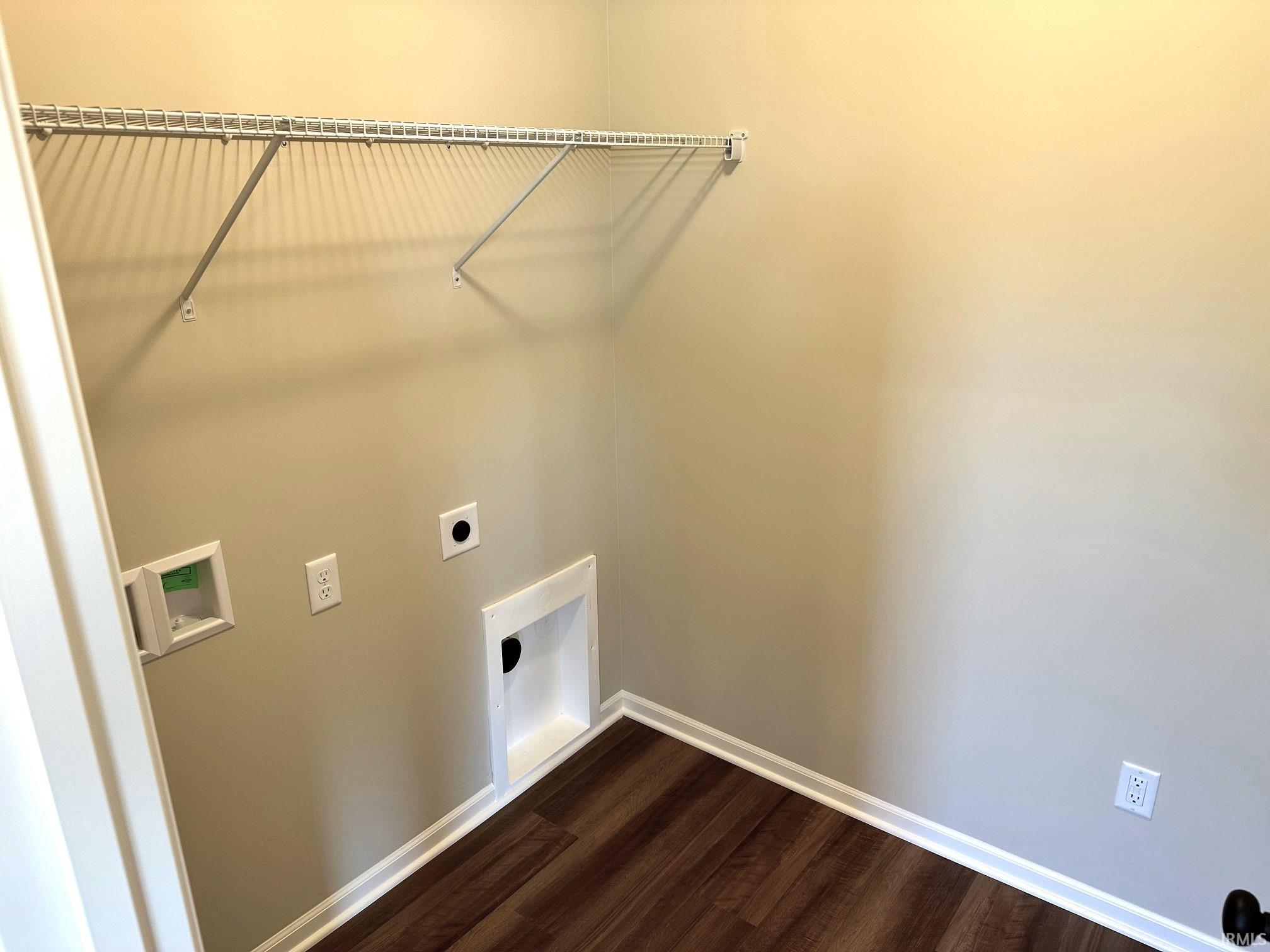 Laundry area with hookup for a washing machine, dark wood-style flooring, and electric dryer hookup