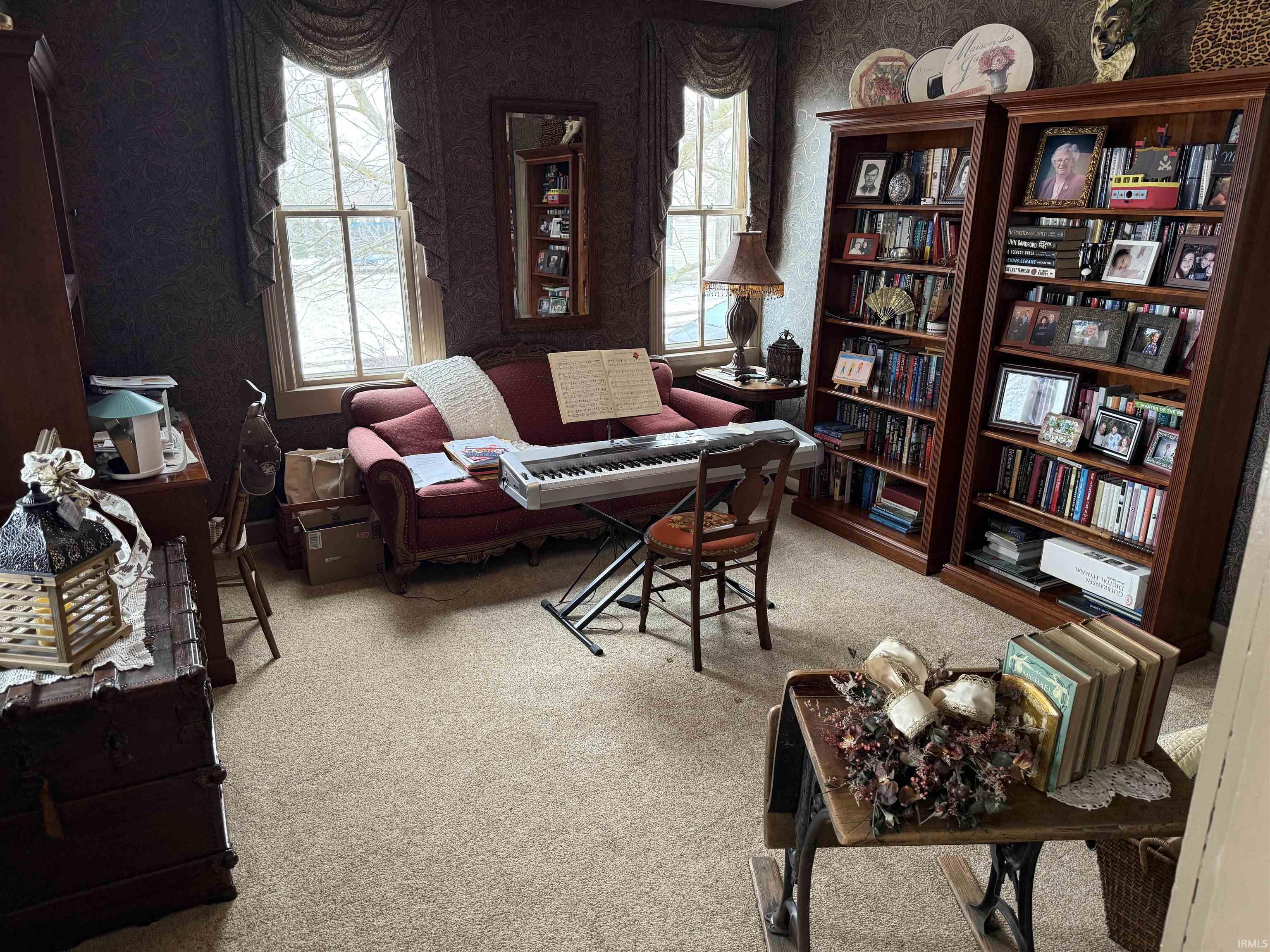 Living area featuring light carpet and wallpapered walls