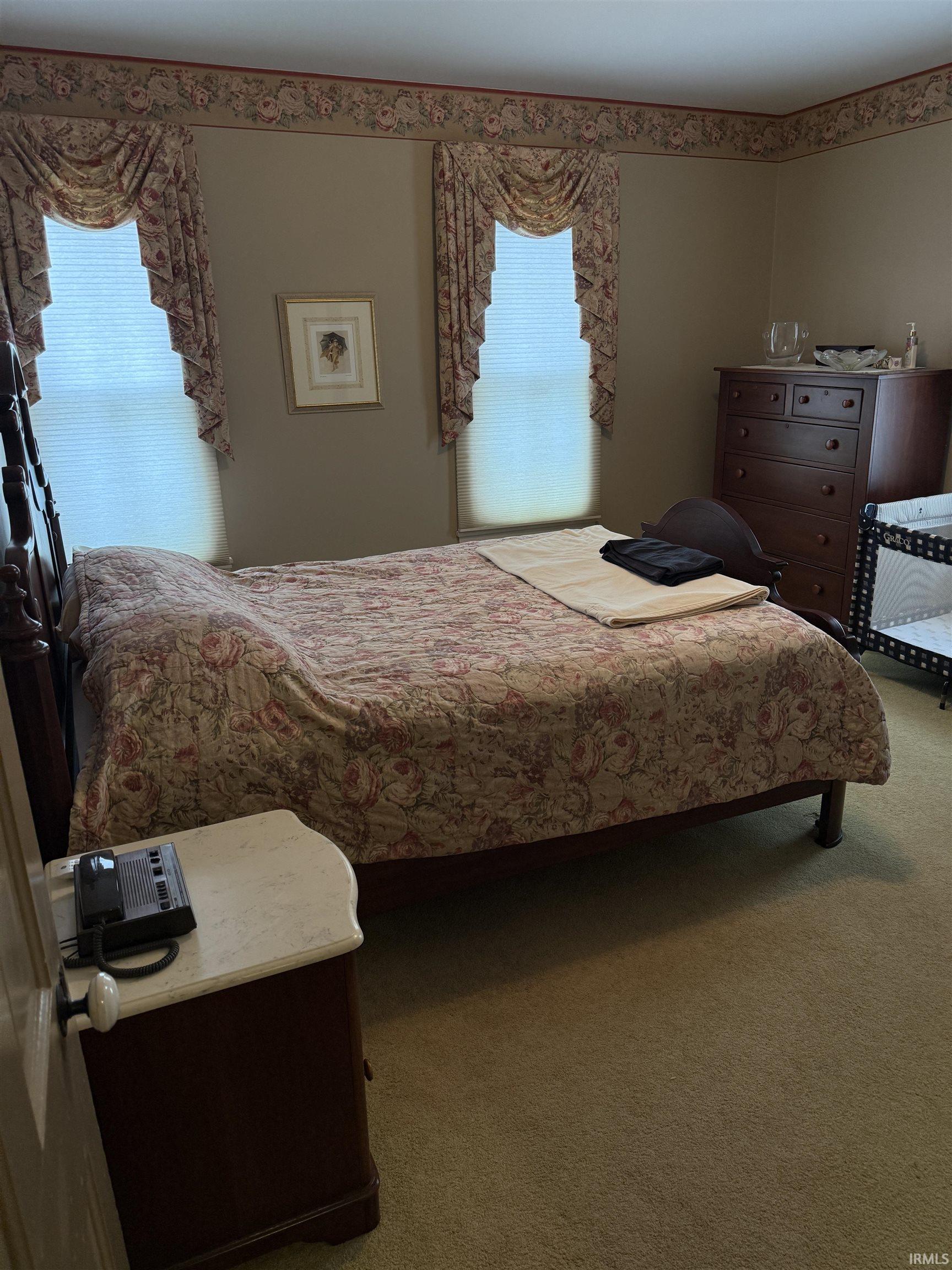 Bedroom featuring carpet and multiple windows