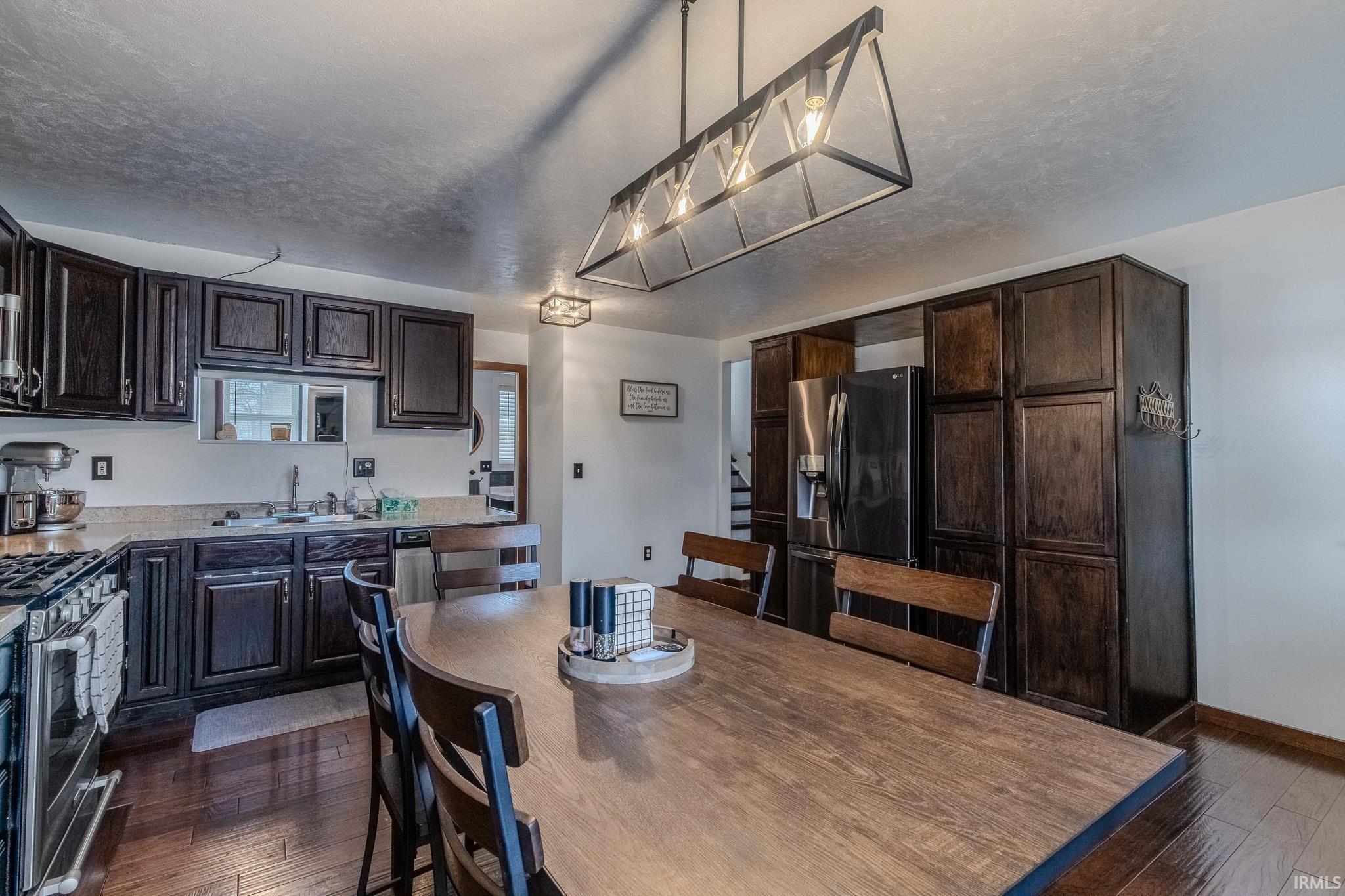 Dining area featuring dark wood finished floors and a textured ceiling