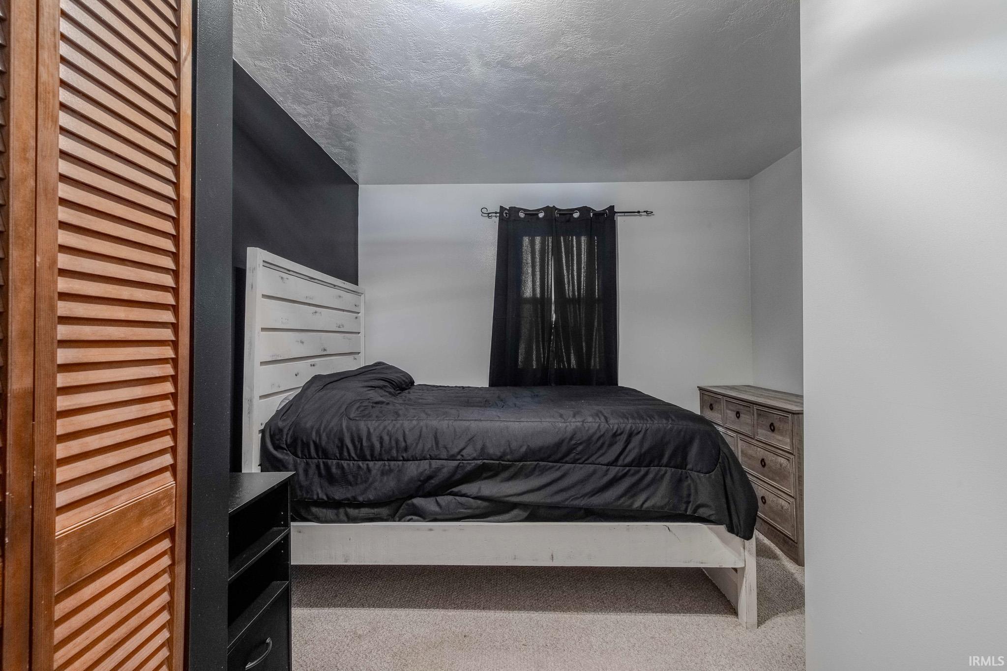 Bedroom with light colored carpet