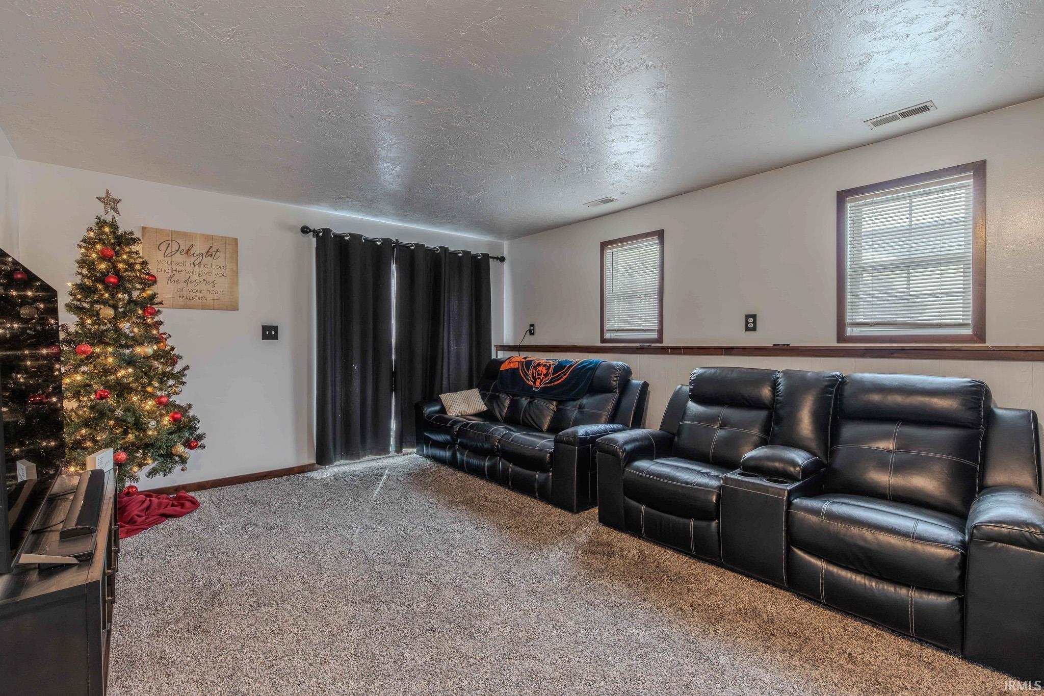 Home theater with carpet and a textured ceiling