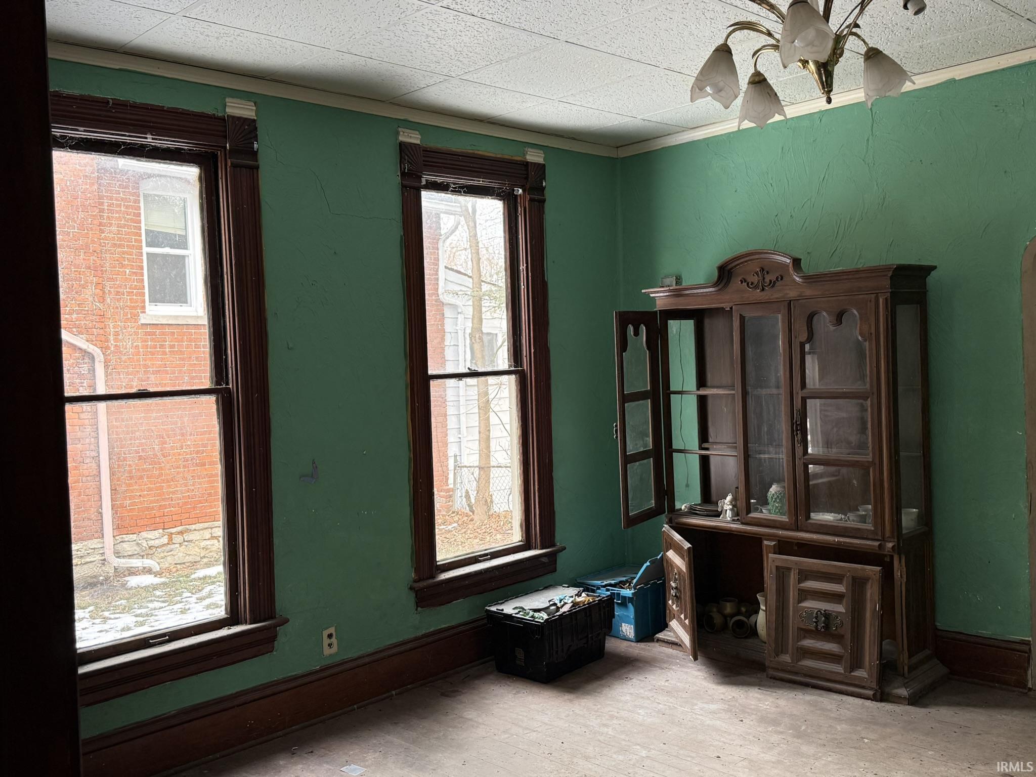 Empty room with wood finished floors and ornamental molding
