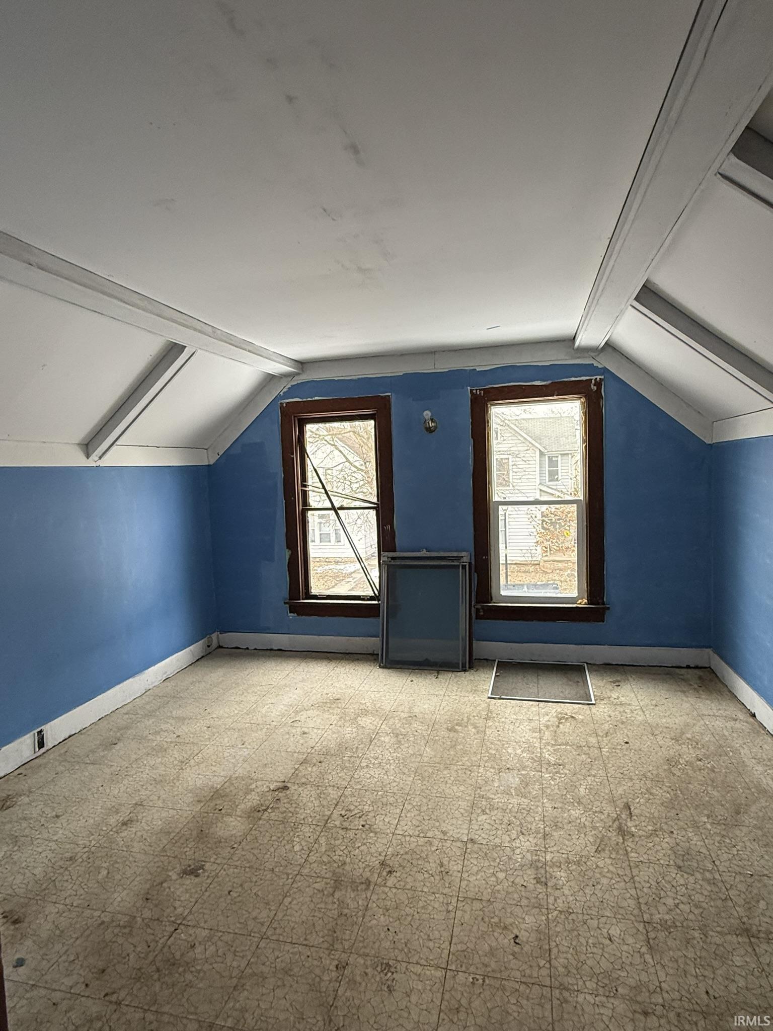 Bonus room featuring baseboards and tile patterned floors