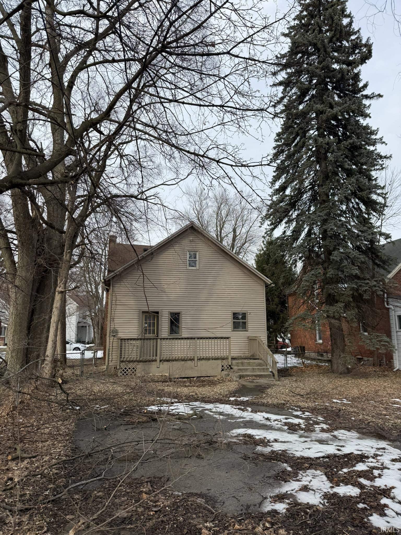 View of home's exterior with a chimney and a deck