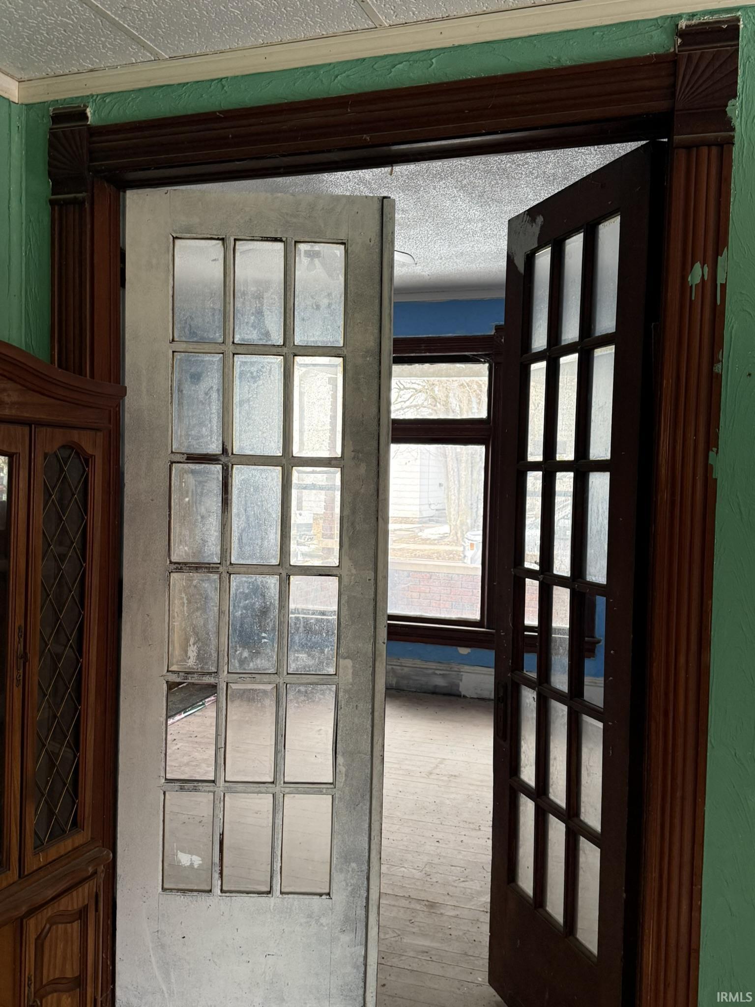 Doorway to outside with a textured ceiling