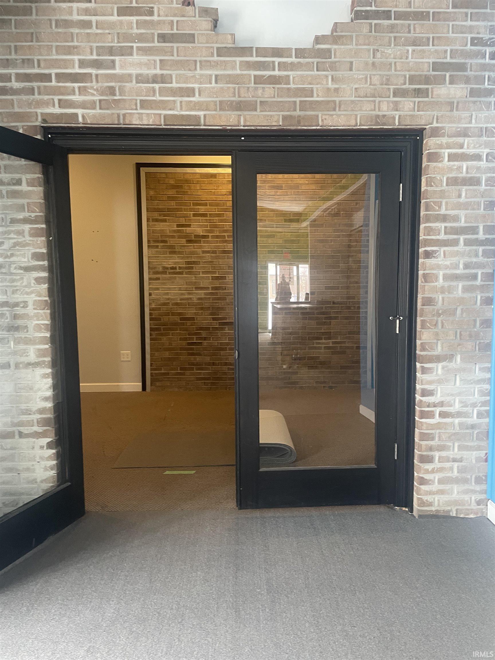 Detailed view of brick wall and carpet flooring