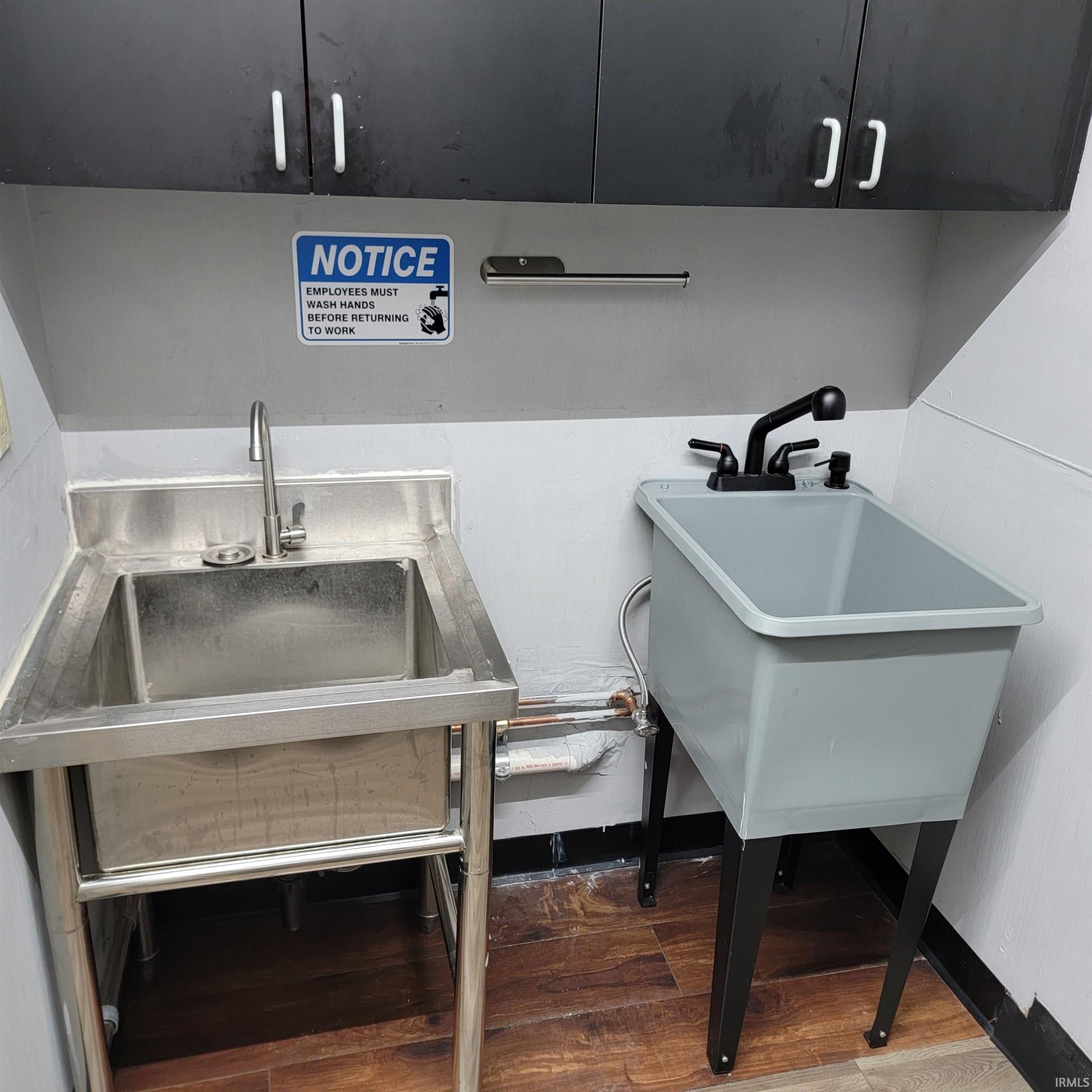 Misc room with dark wood-style floors and a sink