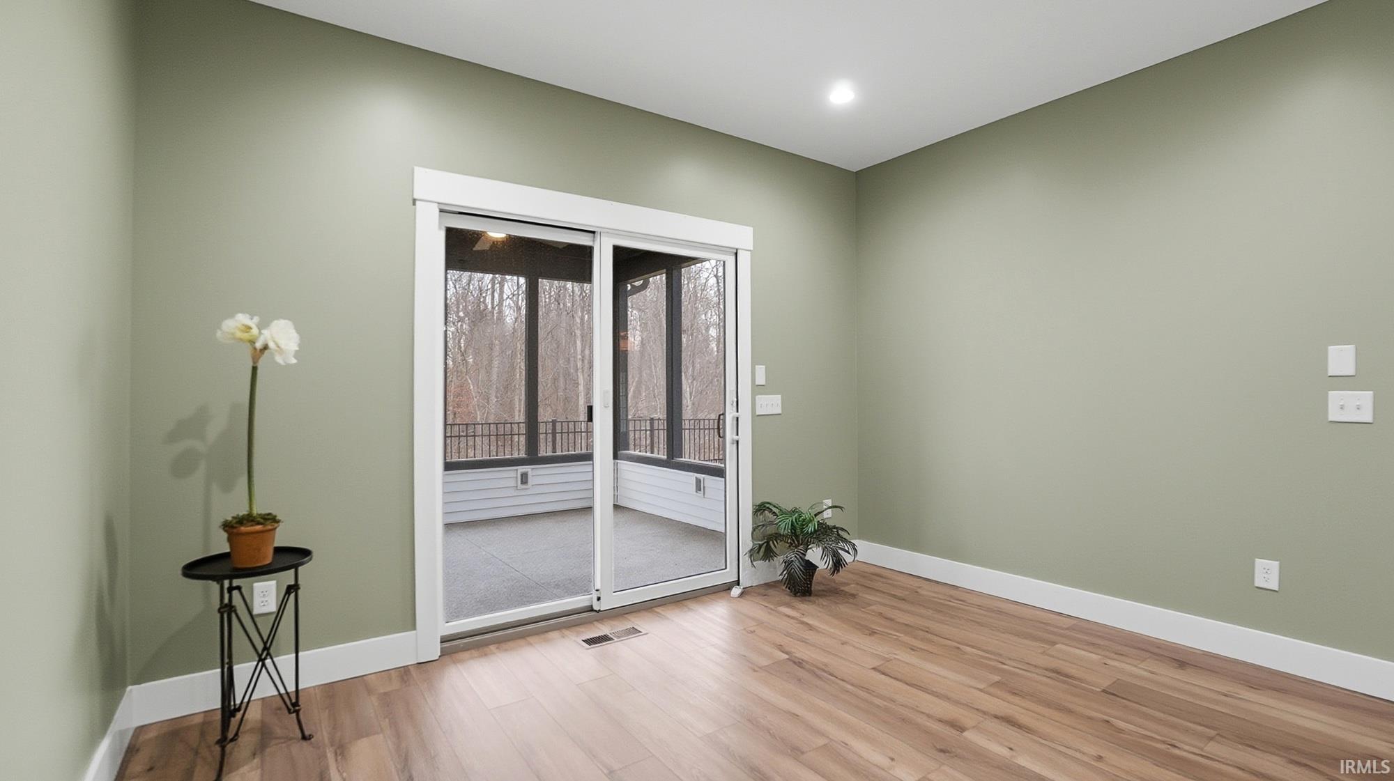 Spare room with light wood-style floors and baseboards