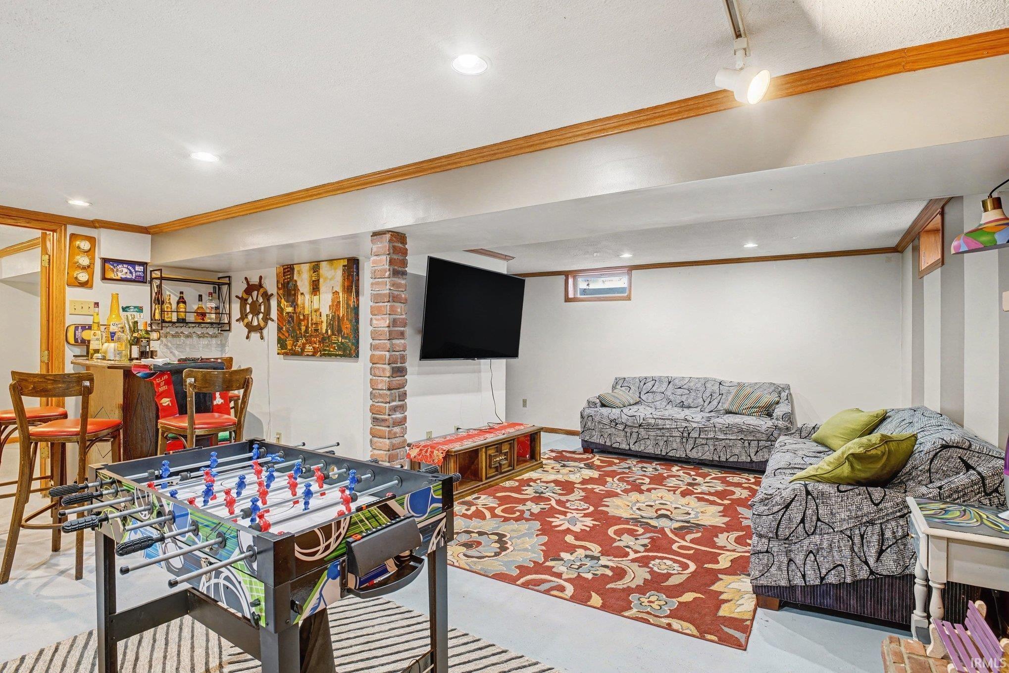 Playroom featuring crown molding, a dry bar, and recessed lighting