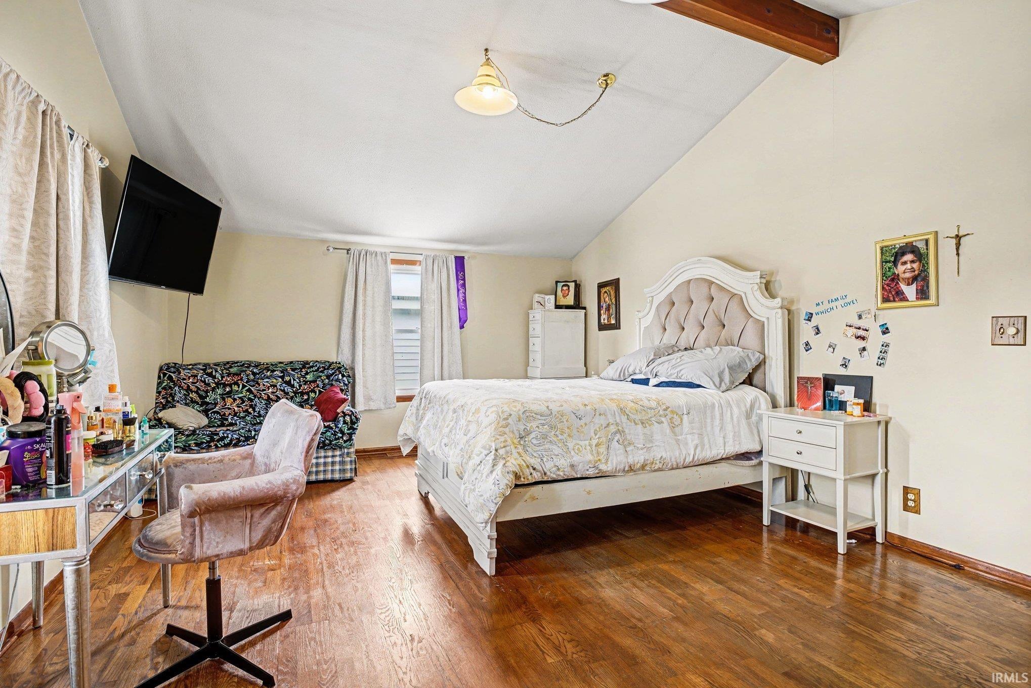 Bedroom featuring vaulted ceiling and hardwood / wood-style floors
