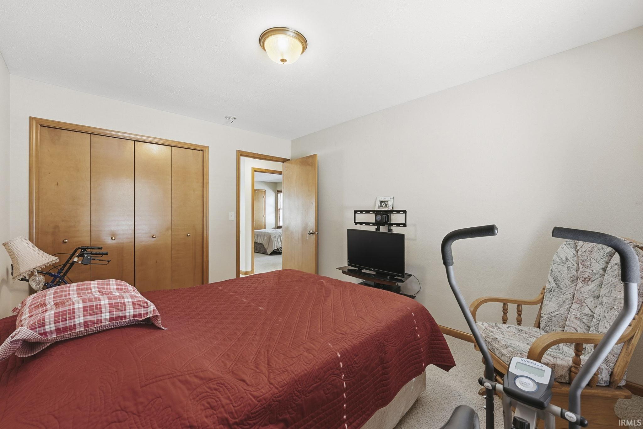 Bedroom featuring carpet floors and a closet