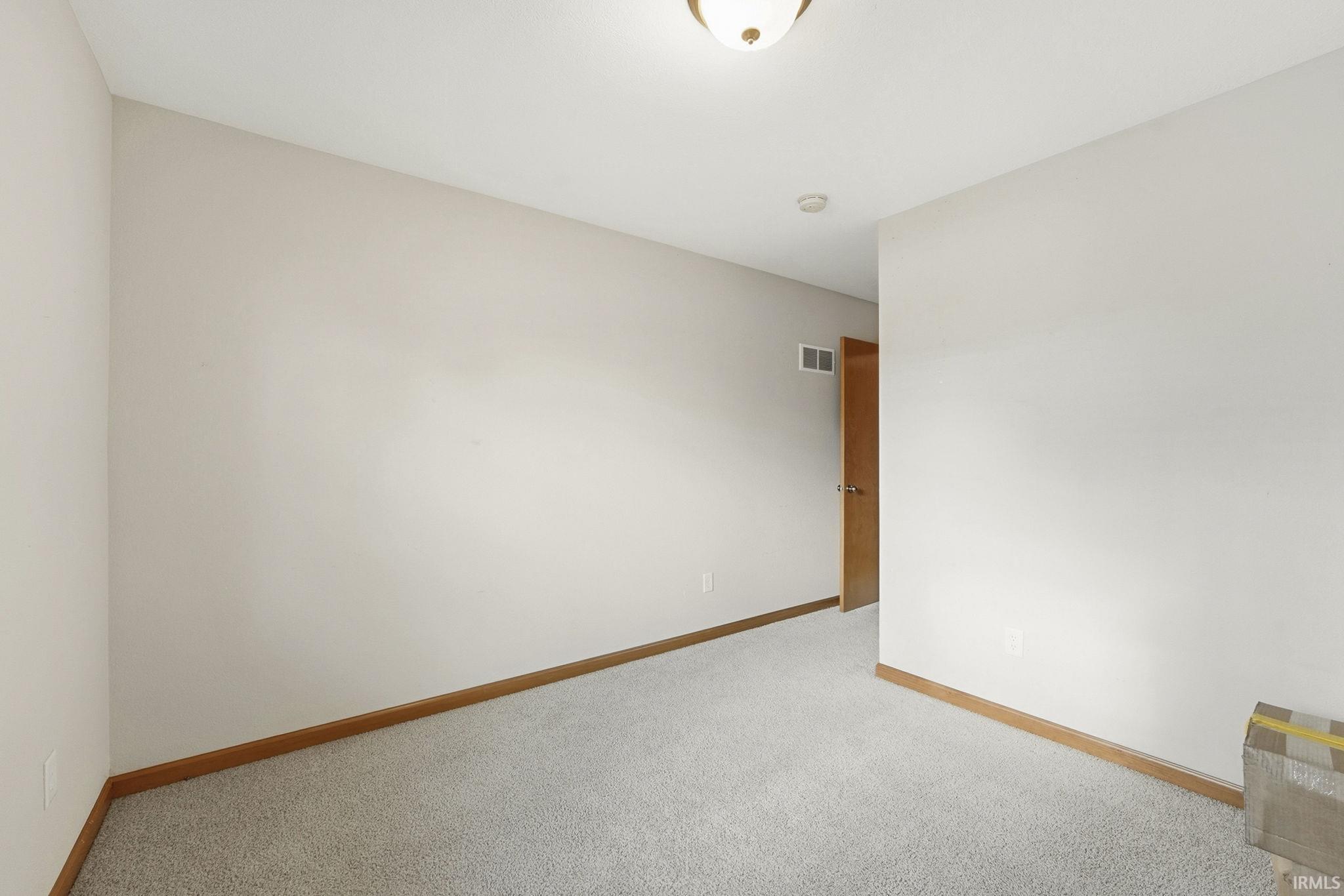 Unfurnished room featuring carpet flooring and baseboards